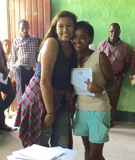Hawi receiving her pay