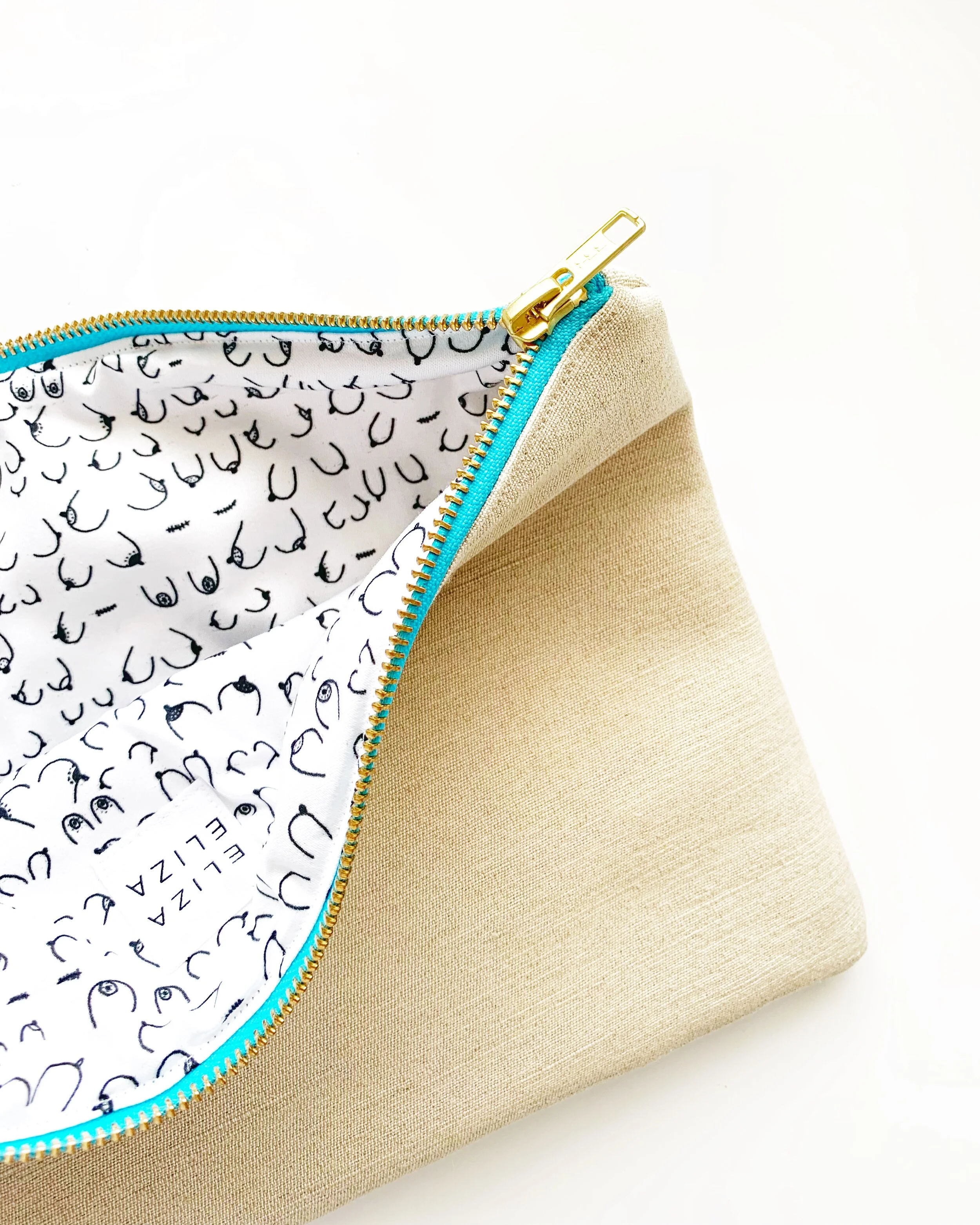 B Collection Clutch bag opened up to show organic cotton lining raising awareness for Breast Cancer Carry Your Cause
