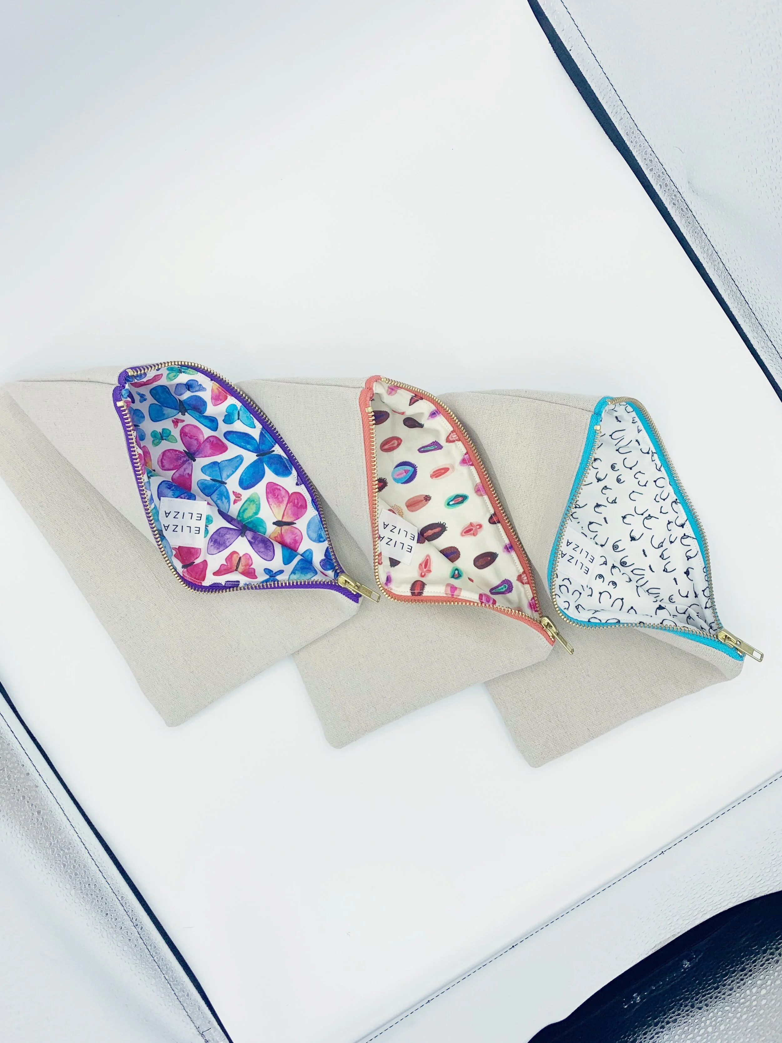 Freedom Collection V Collection B Collection Clutch Bags on light box white background