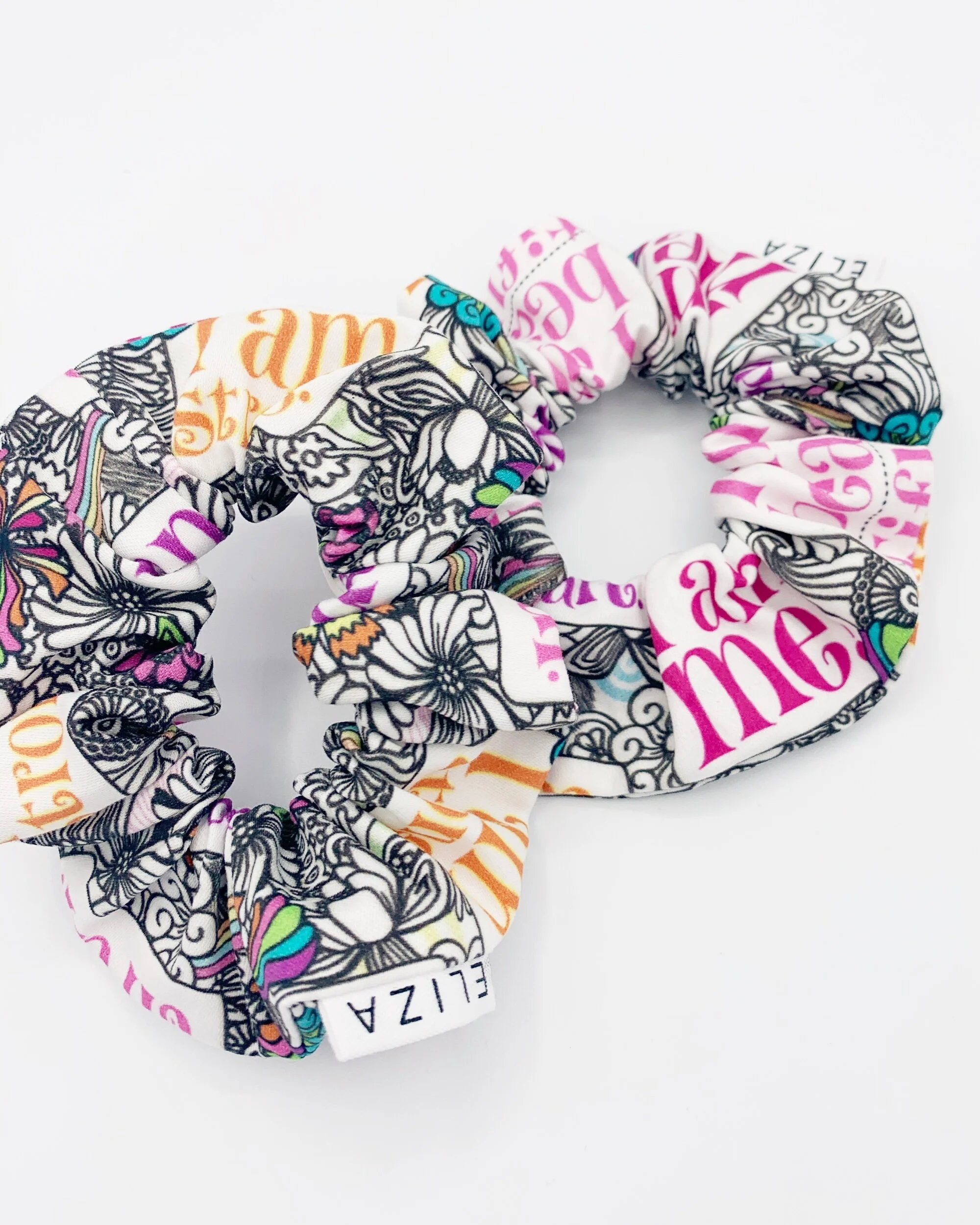 Two I am Me organic cotton scrunchies on white background