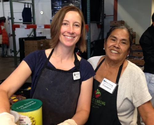 Constance, one of Metro Caring's amazing volunteers, shows Teva the ropes in the warehouse during her first week as CEO