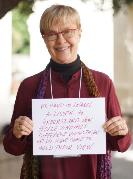  Carolyn Lukensmeyer holds up her takeaways from the conference about inclusion and diversity. 