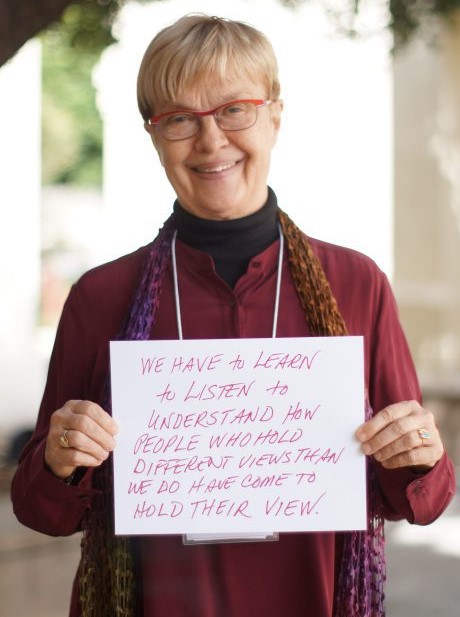 Carolyn Lukensmeyer holds up her takeaways from the conference about inclusion and diversity.