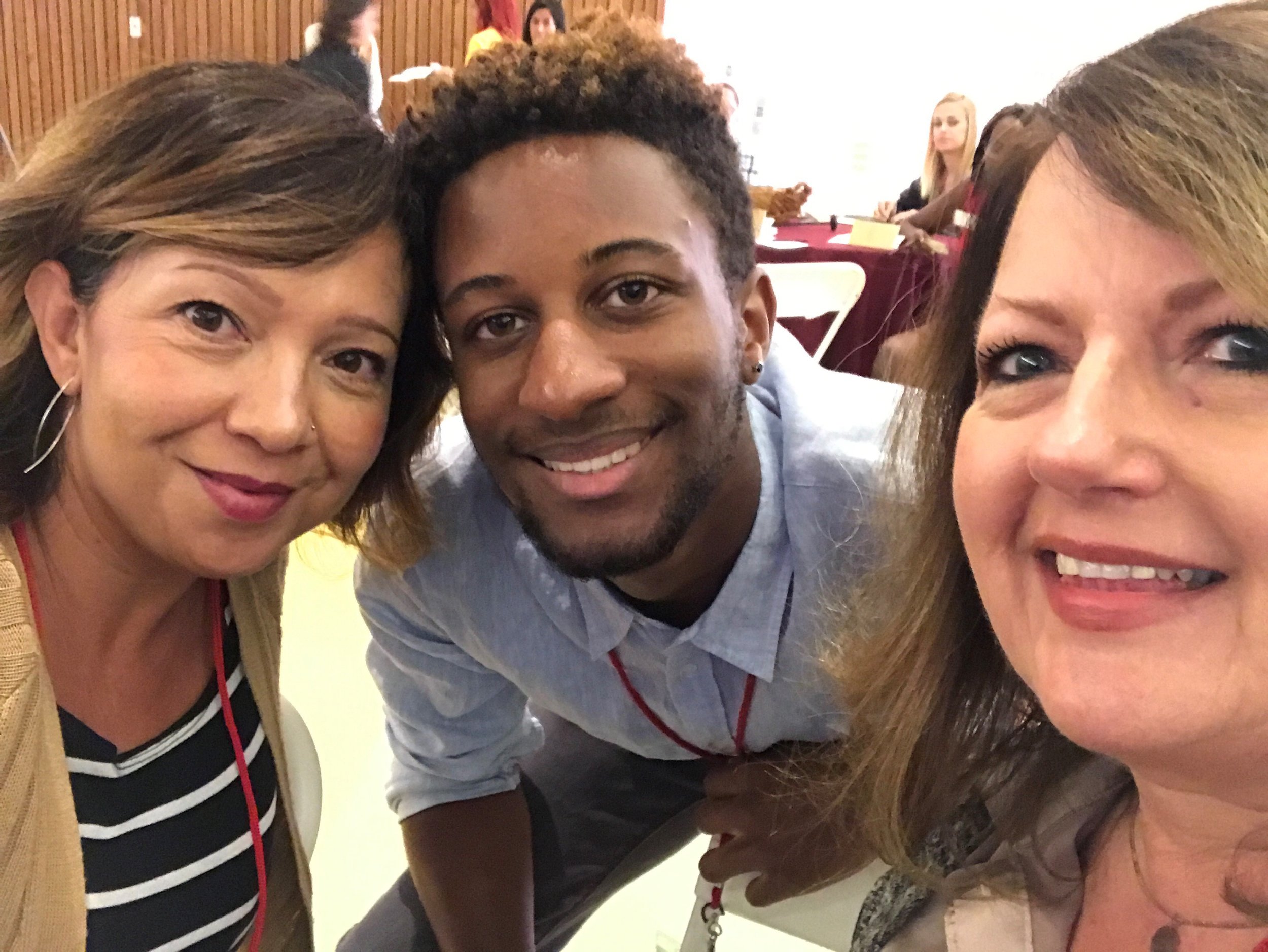 Robert Cain ’21 posing for a photo with staff members from Habitat for Humanity