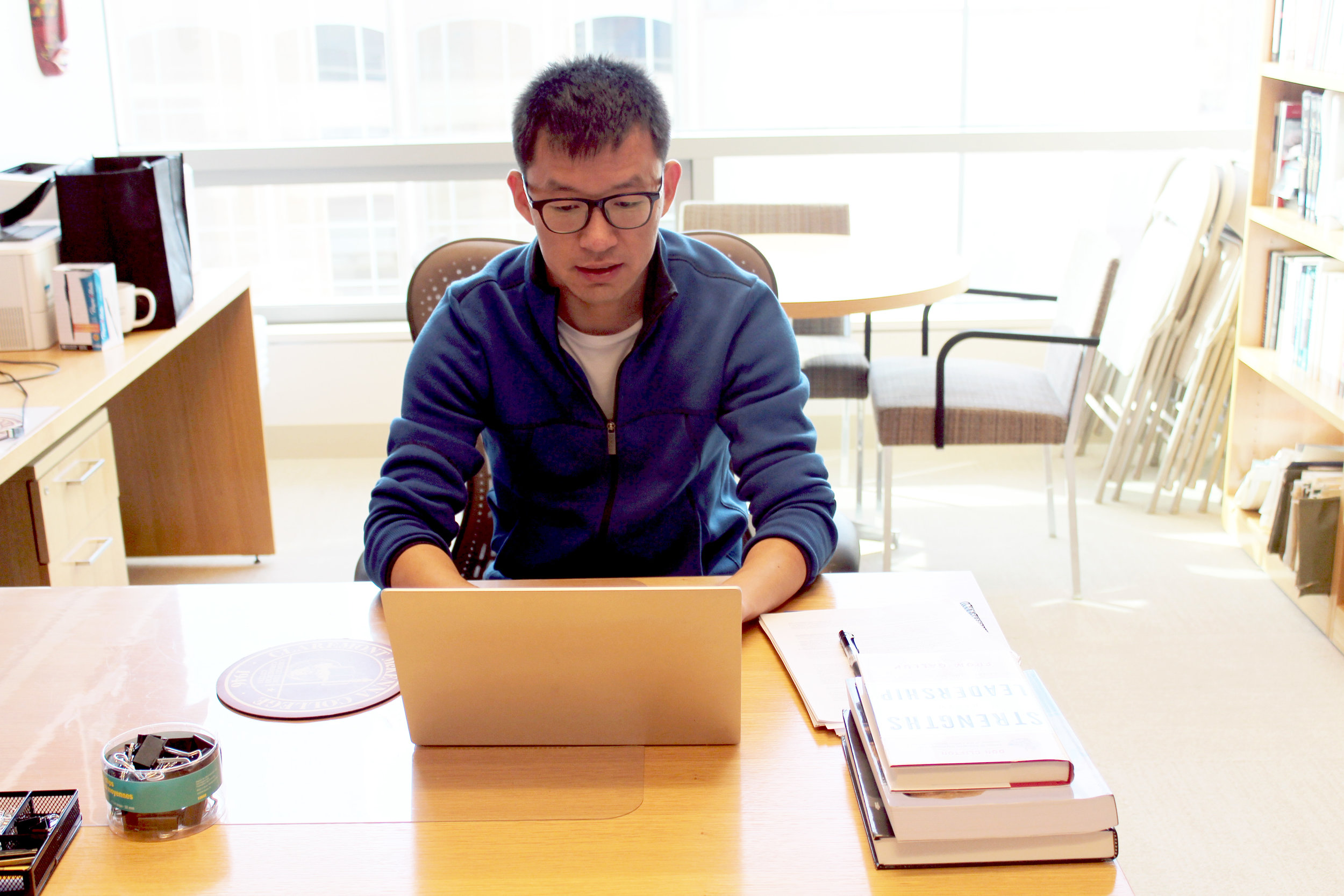 Marko Liu pictured working on leadership research data at Kravis Leadership Institute