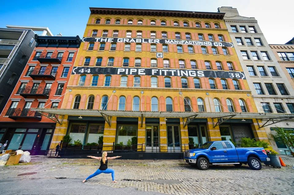 Mary in warrior II in NYC by pipefitter building.jpg