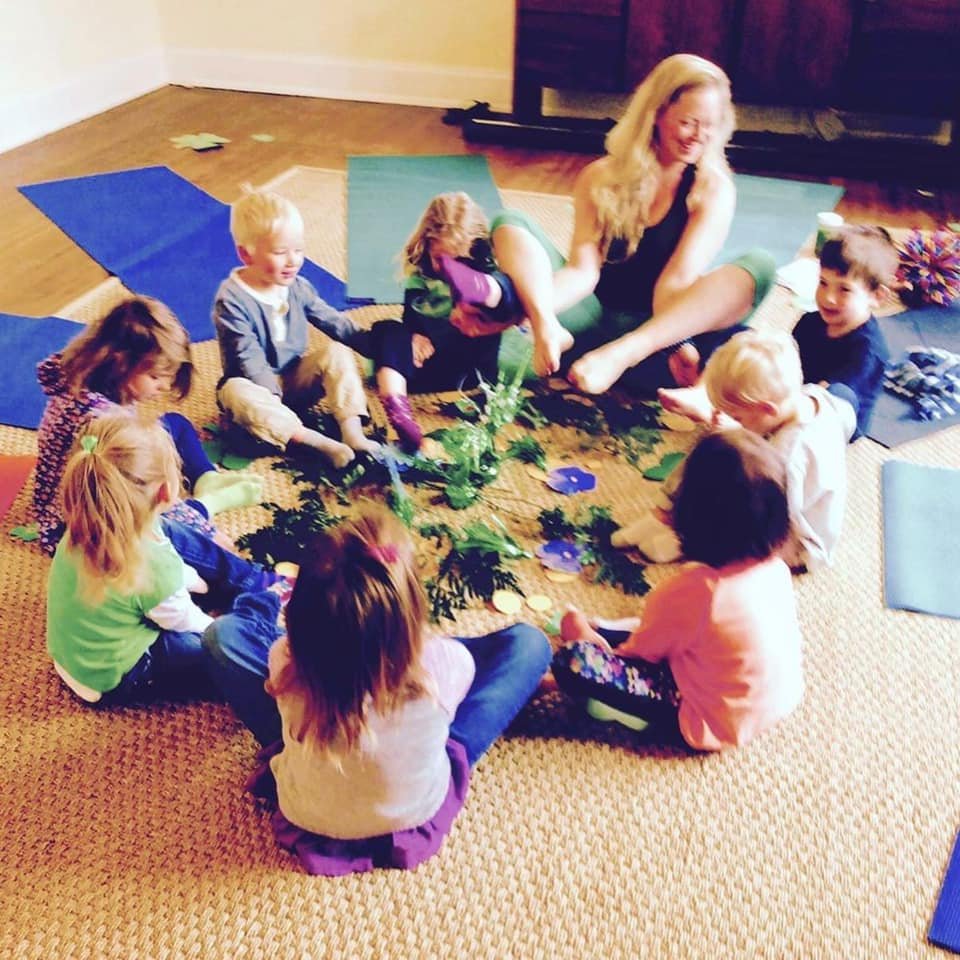 ayfk kids yoga - mary with kids in preschool class in flower pose circle .jpeg