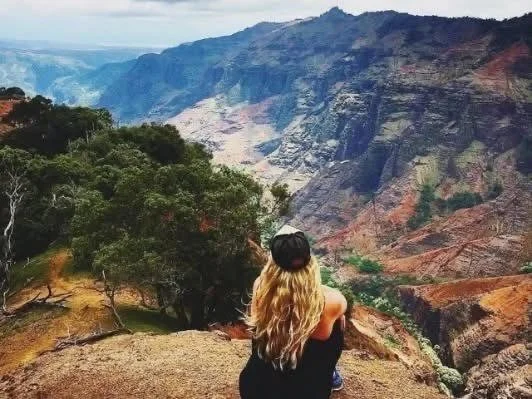 waimea canyojn - Mary looking out at canyon - siting on rock .jpeg