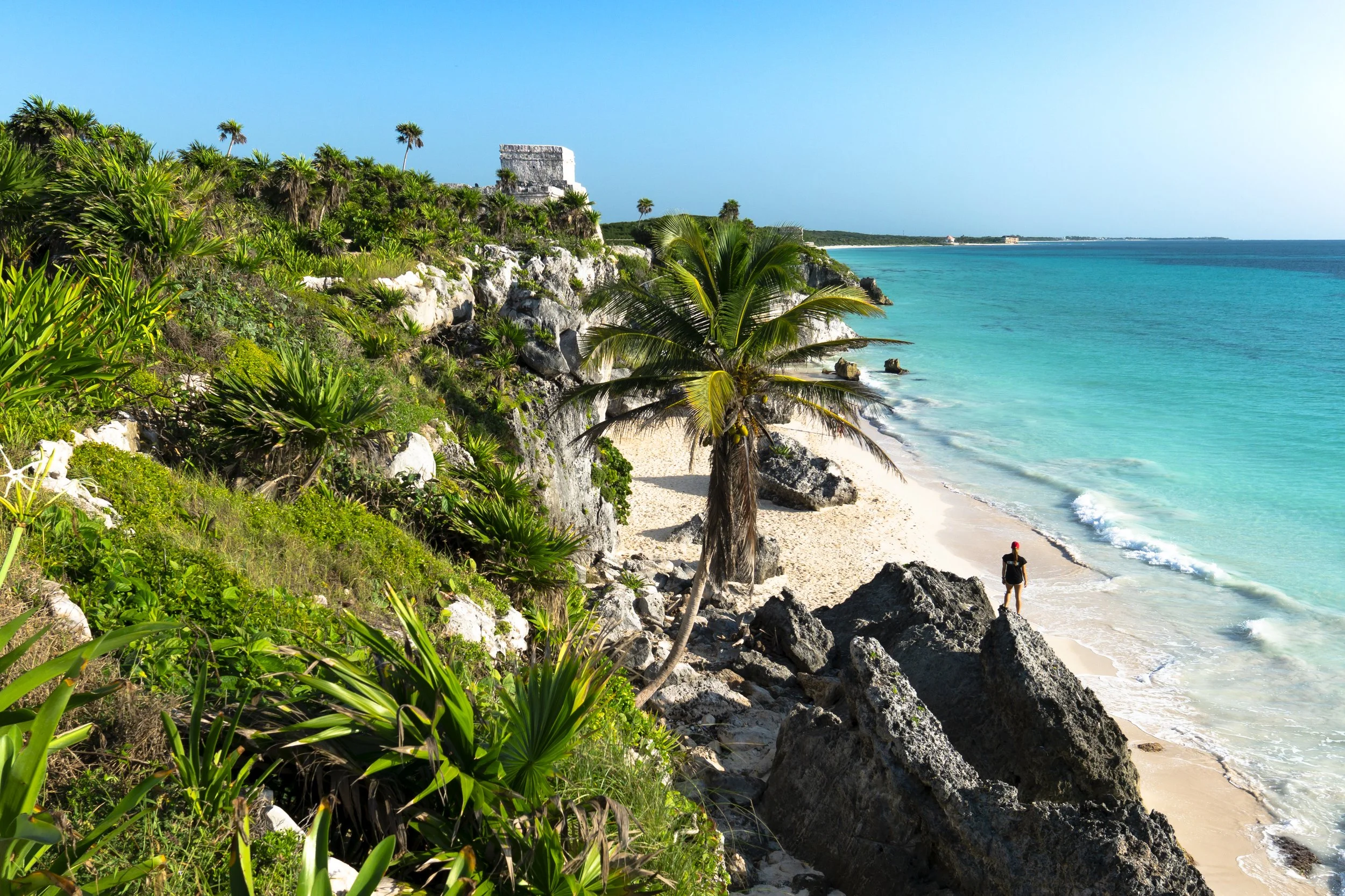 Tulum retreat - woman near beach with view of ruins.jpeg