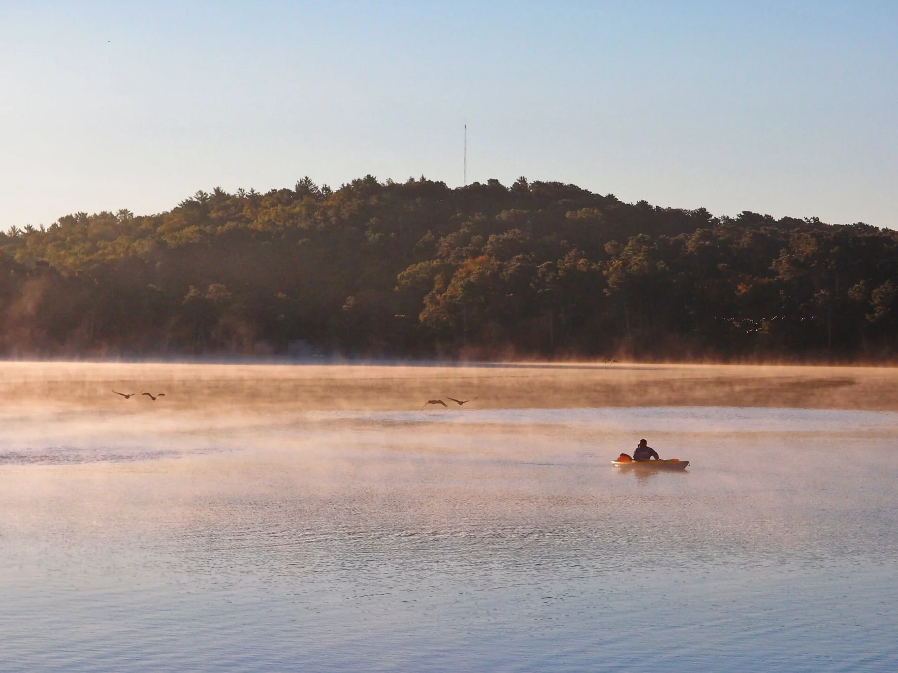 cape cod yoga retreat - perosn on kayak on lake .jpeg