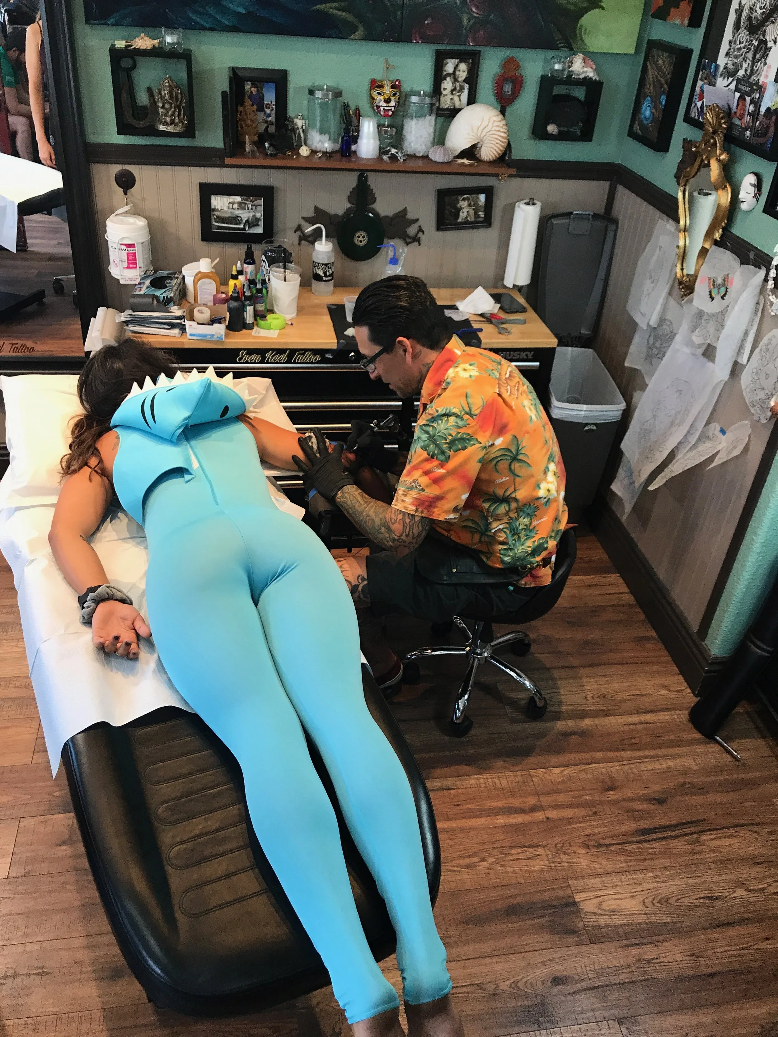 Client in shark costume getting tatttoo