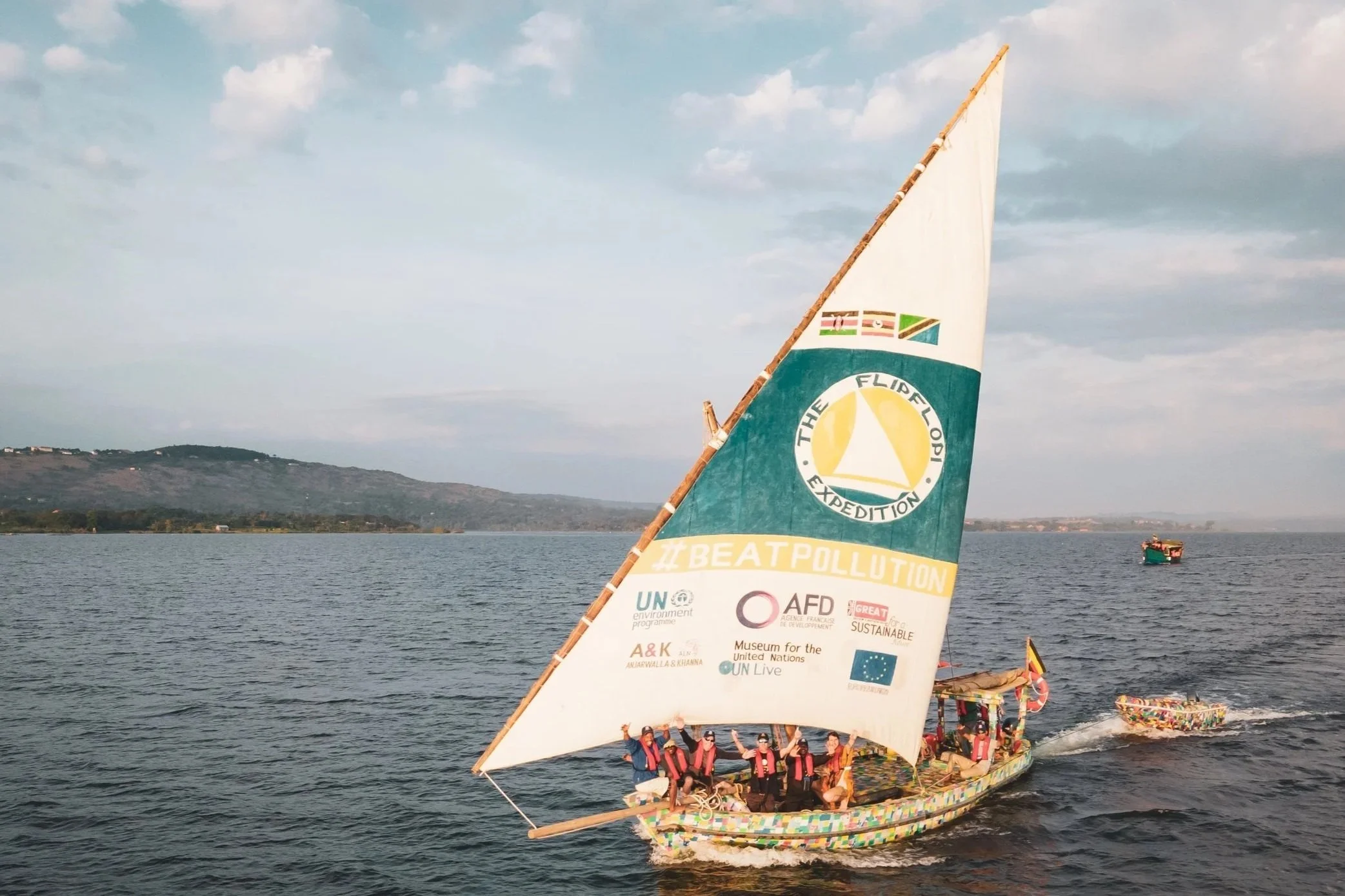 Flipflopi Ndogo a recycled plastic sailing dhow on the water with the sail up in the Indian ocean
