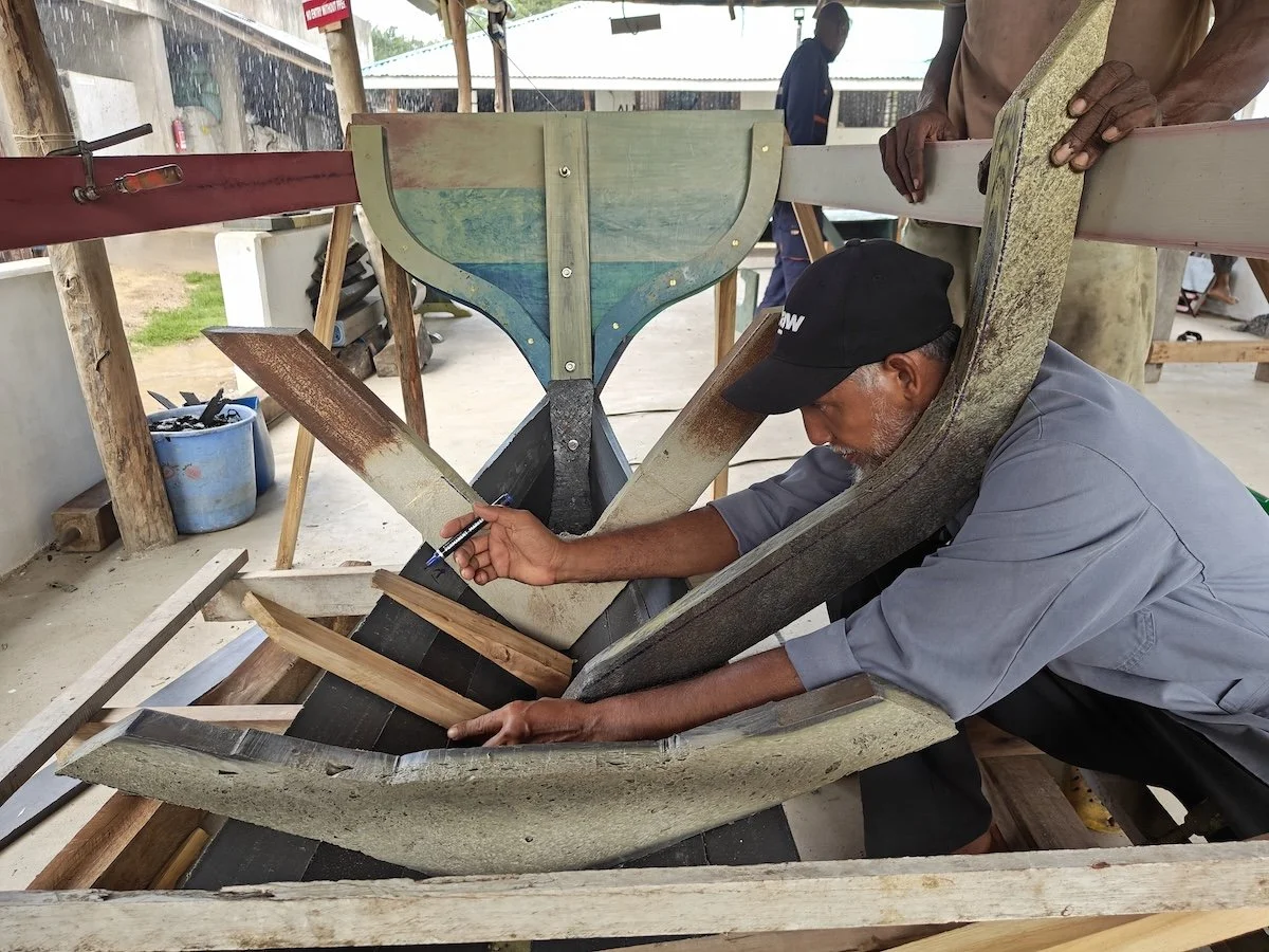 The ribs of a boat are shown while one of Lamu's traditional boatbuilders is working on building the rest of the boat.