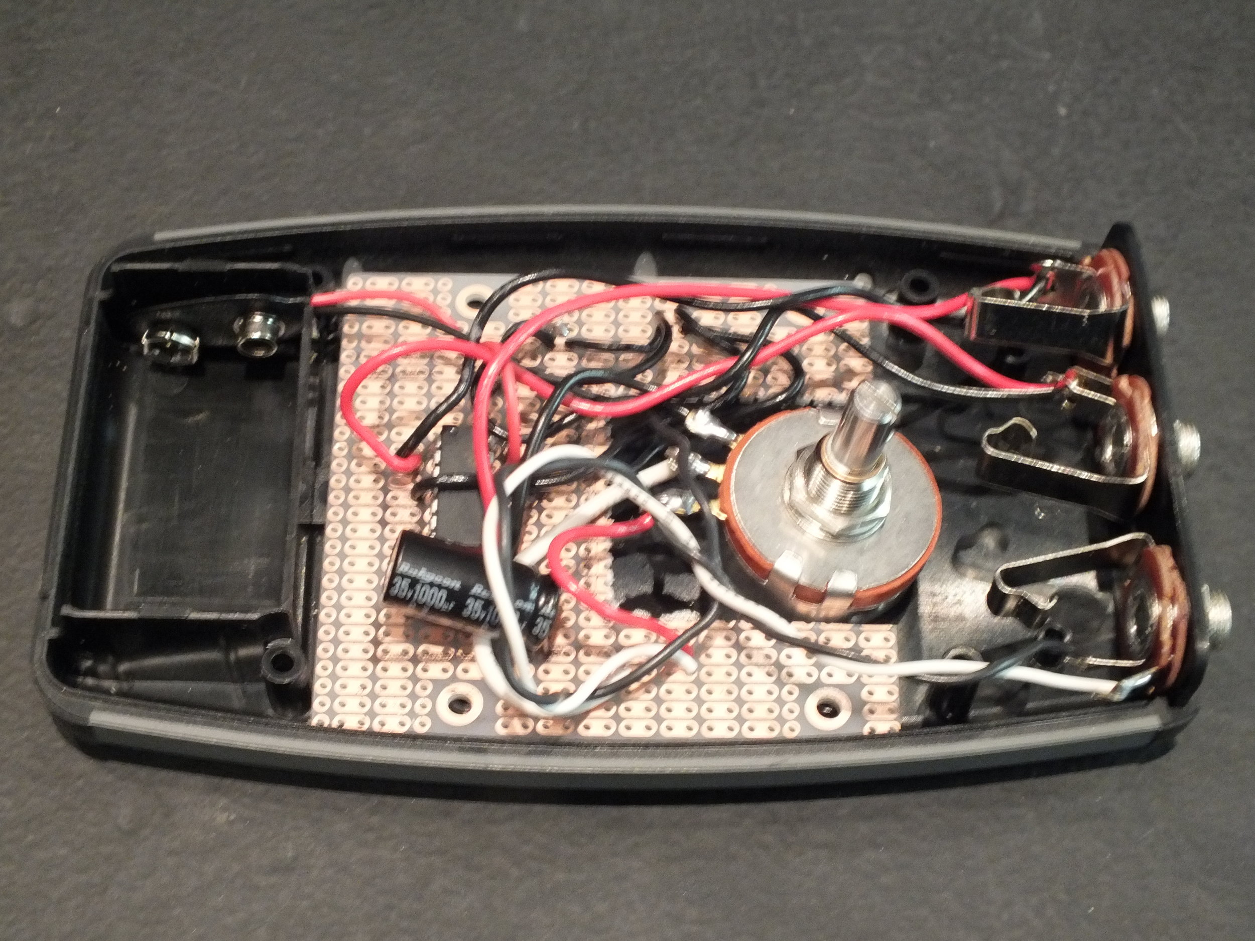 Following the testing phase, I permanently soldered the capacitors and amplifier circuit into a prototyping box purchased at a local electronics shop.
