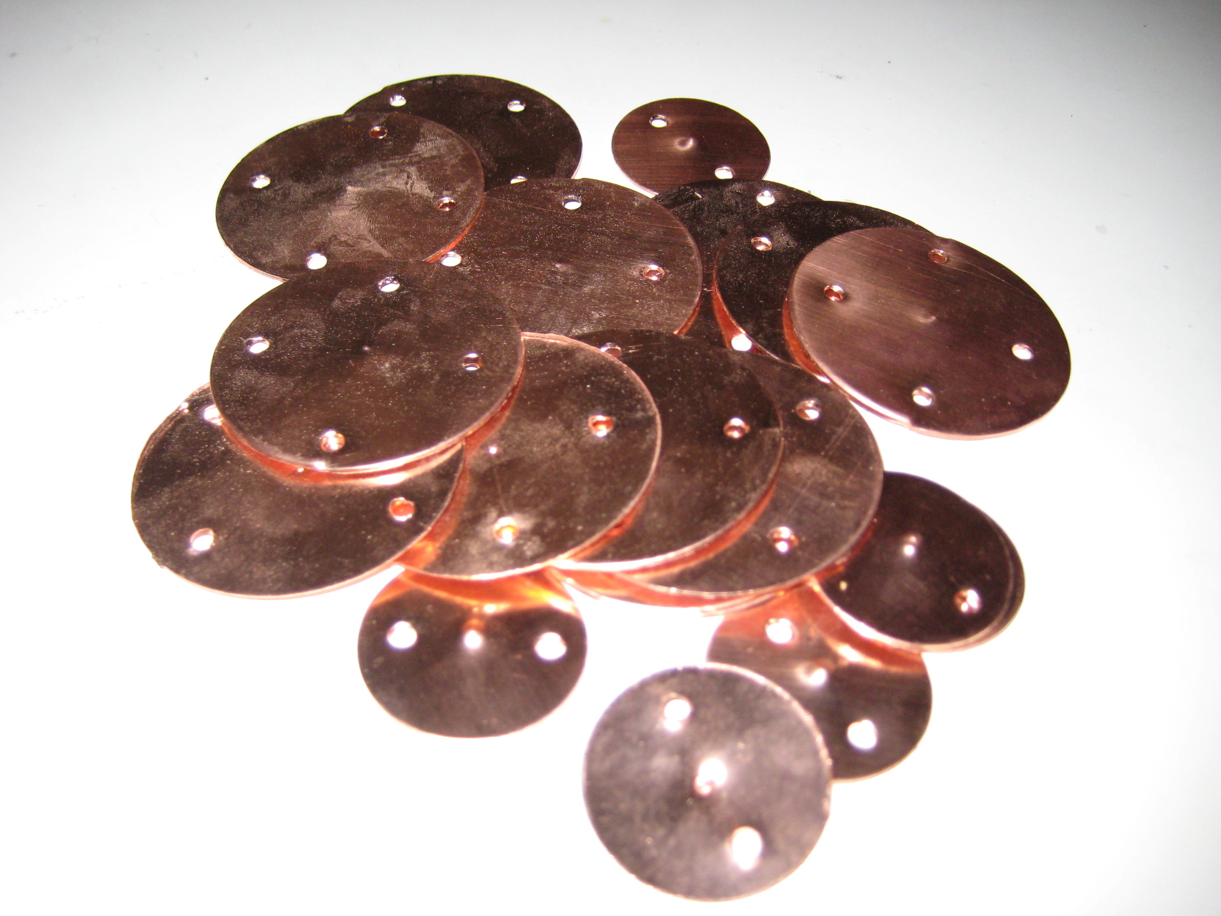The capacitors were extended via copper discs with long wires and sewn onto the palms of a pair of gloves purchased at an adult novelty store. I had the small discs punched-out of a copper sheet by industrial design students with whom I was collaborating on another interactive project.