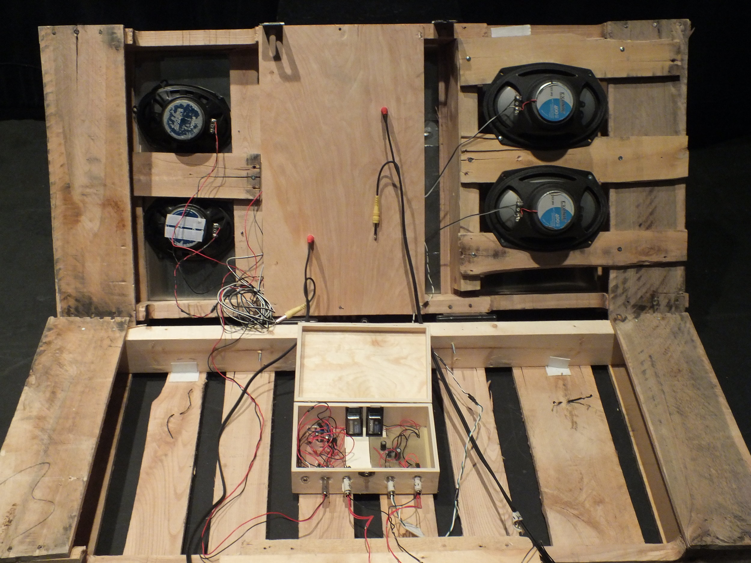 In order to have easy access to the circuit and speakers in case of damage, the two halves of the skid are connected with a pair of hinges, essentially creating a lid to allow for access to the circuits when needed. Several slats were then removed from the inside of the palette to allow room for the speakers to be affixed directly underneath the sheet metal.