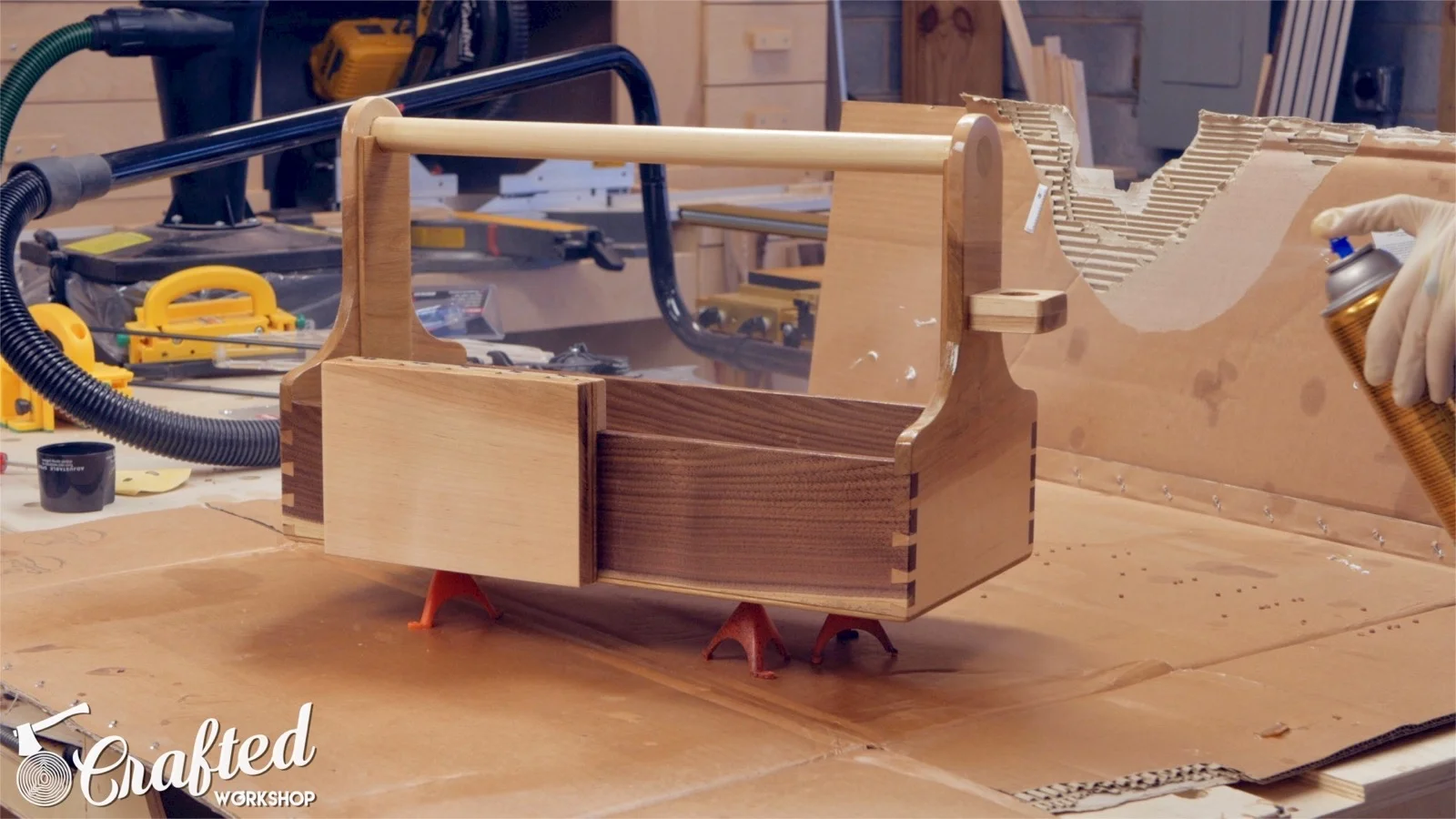 applying spray polyurethane on hand tool tote