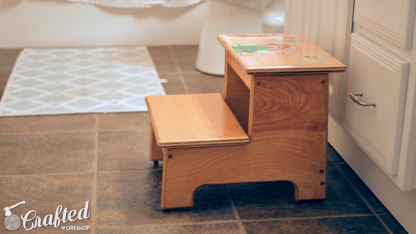 kid's step stool in front of bathroom sink