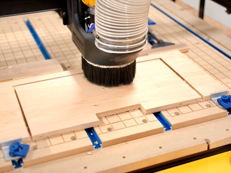 Once I had the design setup in Easel, I moved over to my X-Carve and got it set up to cut the template from a scrap piece of ½” plywood. I actually had the X-Carve cut the handle cutout and a rectangle surrounding the cutout, as this would ensure th…