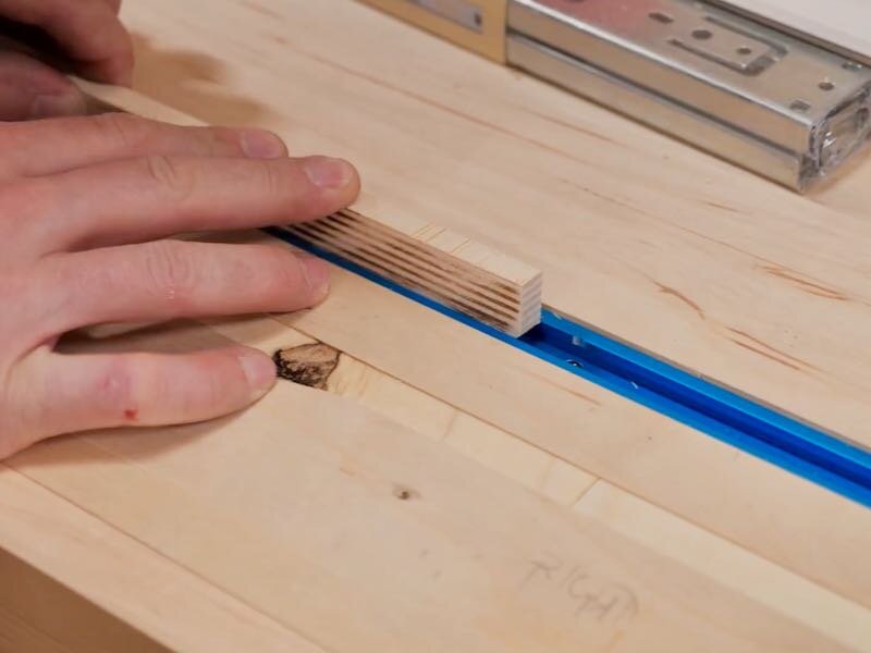 Cut your plywood to fit and slide in the t-track.