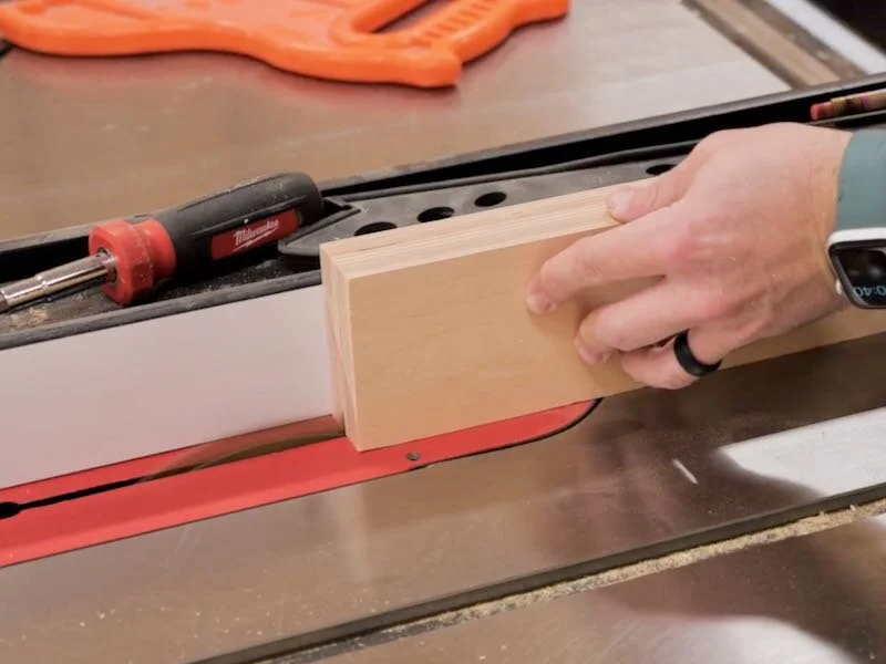 Cutting the slot to accept the t-track on the plywood fence at that table saw.