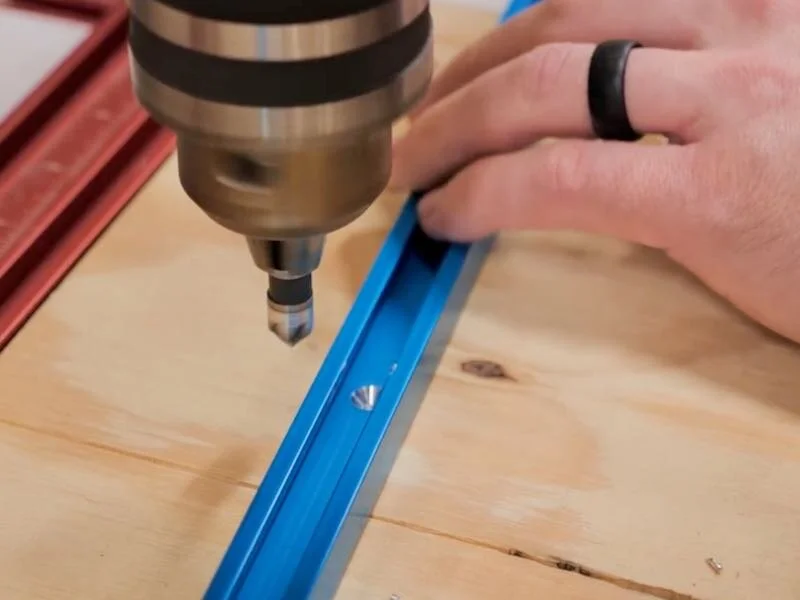 Counter sinking pilot holes in aluminum t-track using low rpms on the drill press.