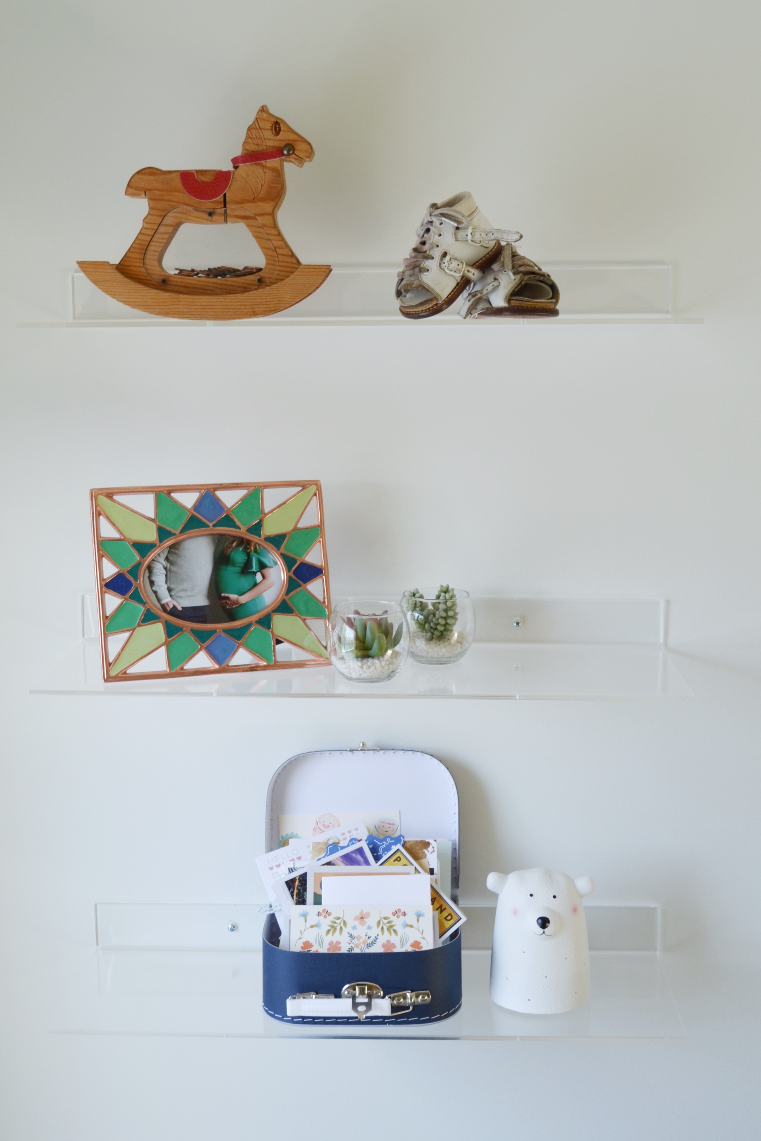 Nursery Shelves housing mementos from our childhood, a photo from our maternity shoot and cards from my baby showers.