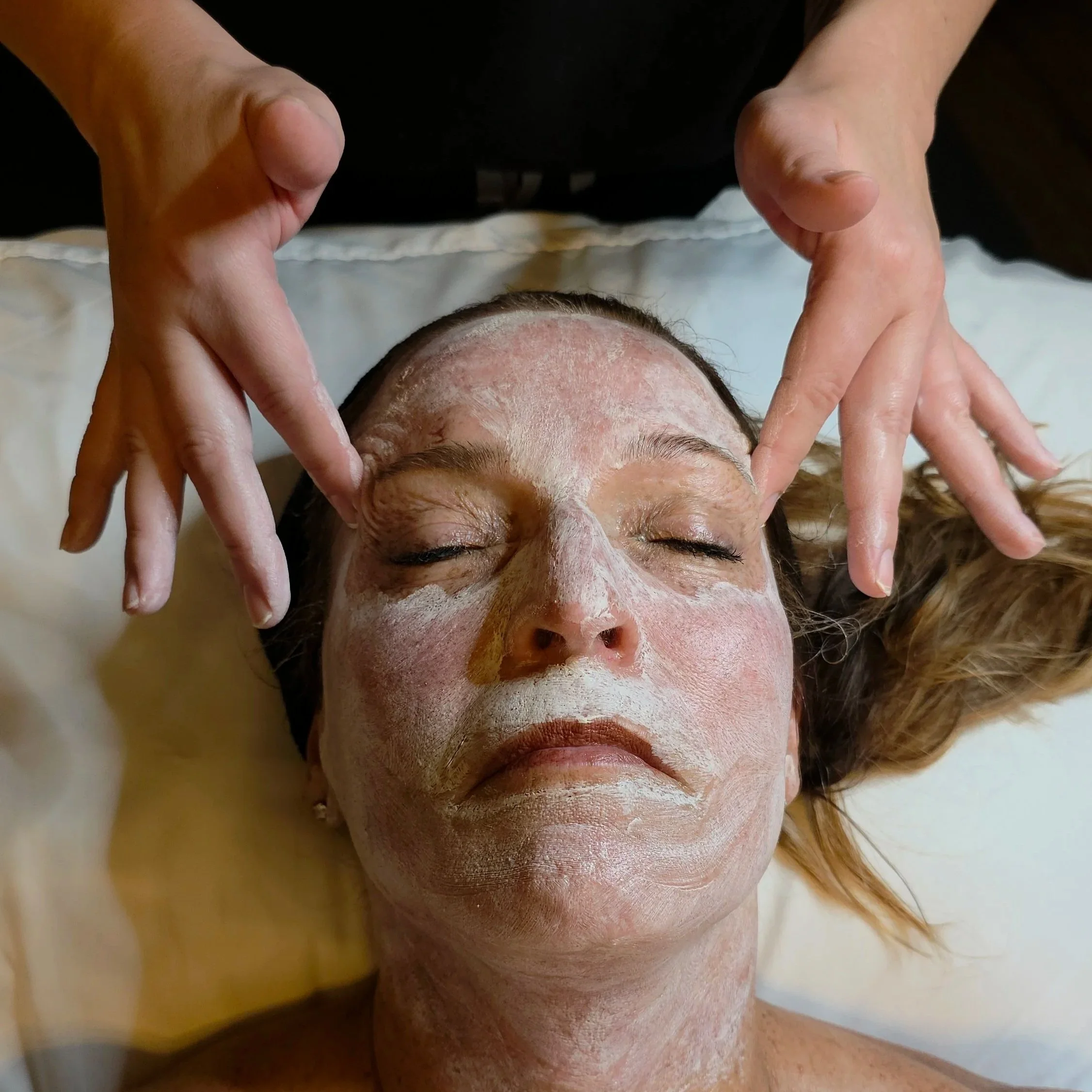 Client relaxing in a hydrating mask during The Red Carpet Ready Facial  at The Laser Loft in Gahanna Ohio