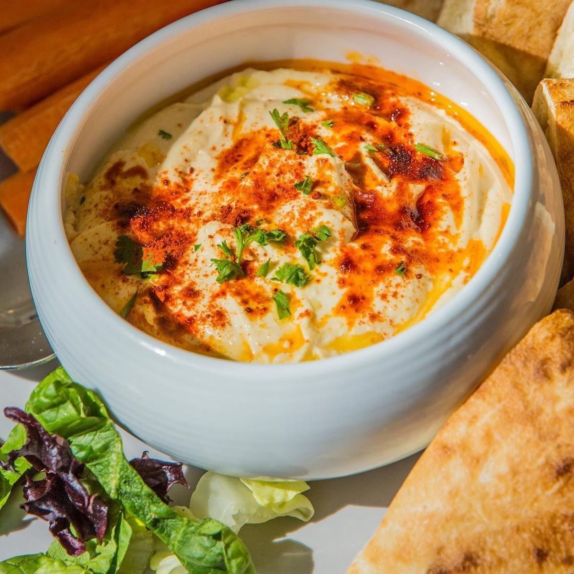 We have had many different dishes on our menu throughout the years. However, one dish that will always remain is hummus. Made with chickpeas and tahini, it is entirely vegan. Join us from Tuesday to Saturday, between 11 AM - 9 PM (10 PM on Fridays an