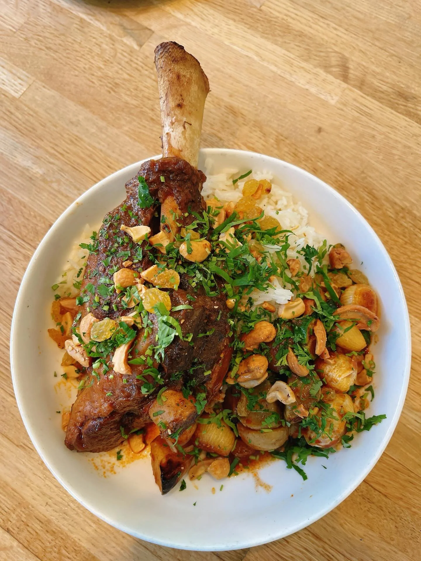 Lamb Mendi - braised lamb shank with zucchini, onion, and potato, served with smoked basmati rice, golden raisin &amp; cashew garnish. 

&ldquo;Lamb mendi is a labor of love and a gesture of care for guests. I remember my aunties taking over our kitc