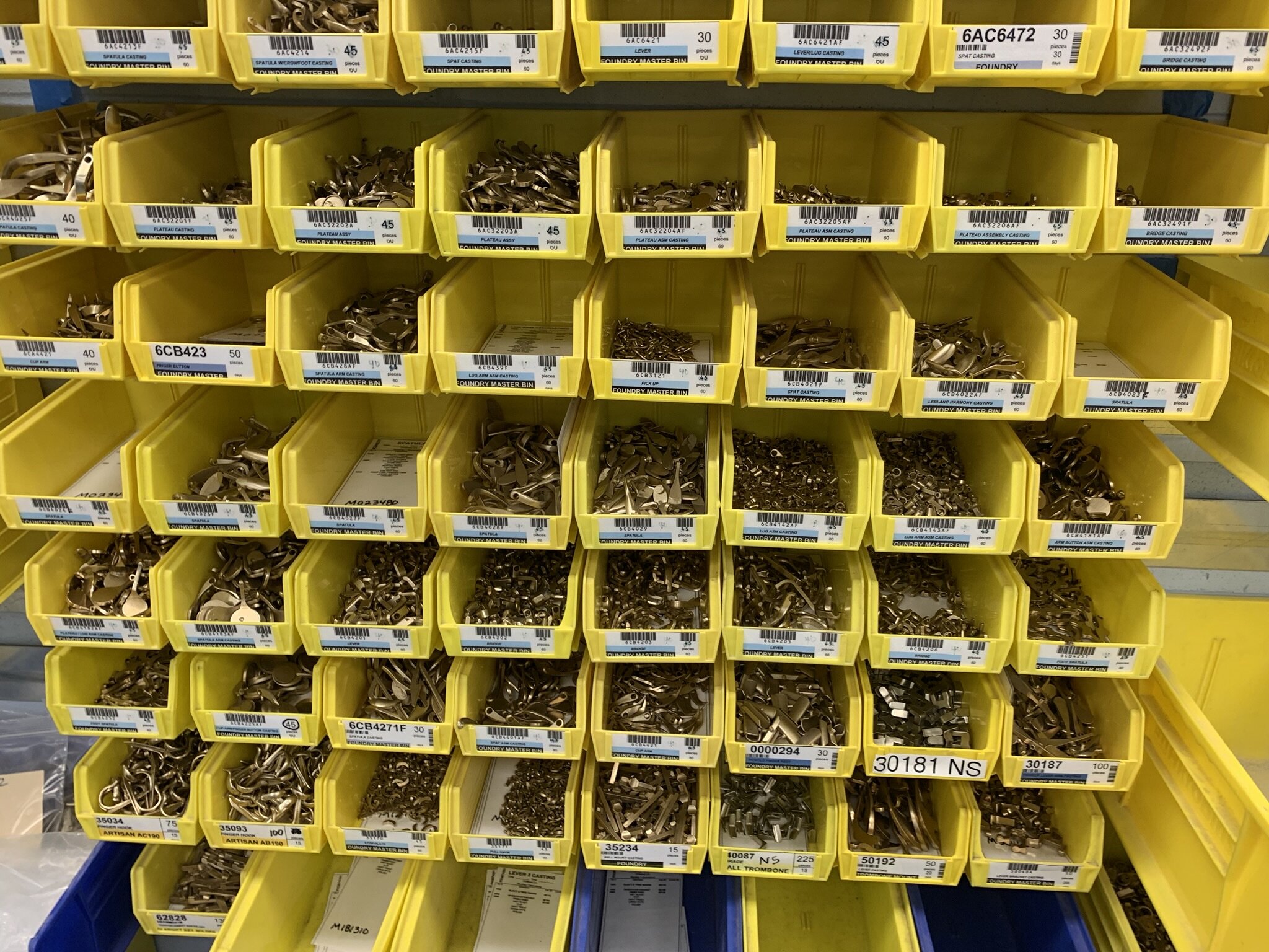 Bins of keys are organized and catalogued for each woodwind family.