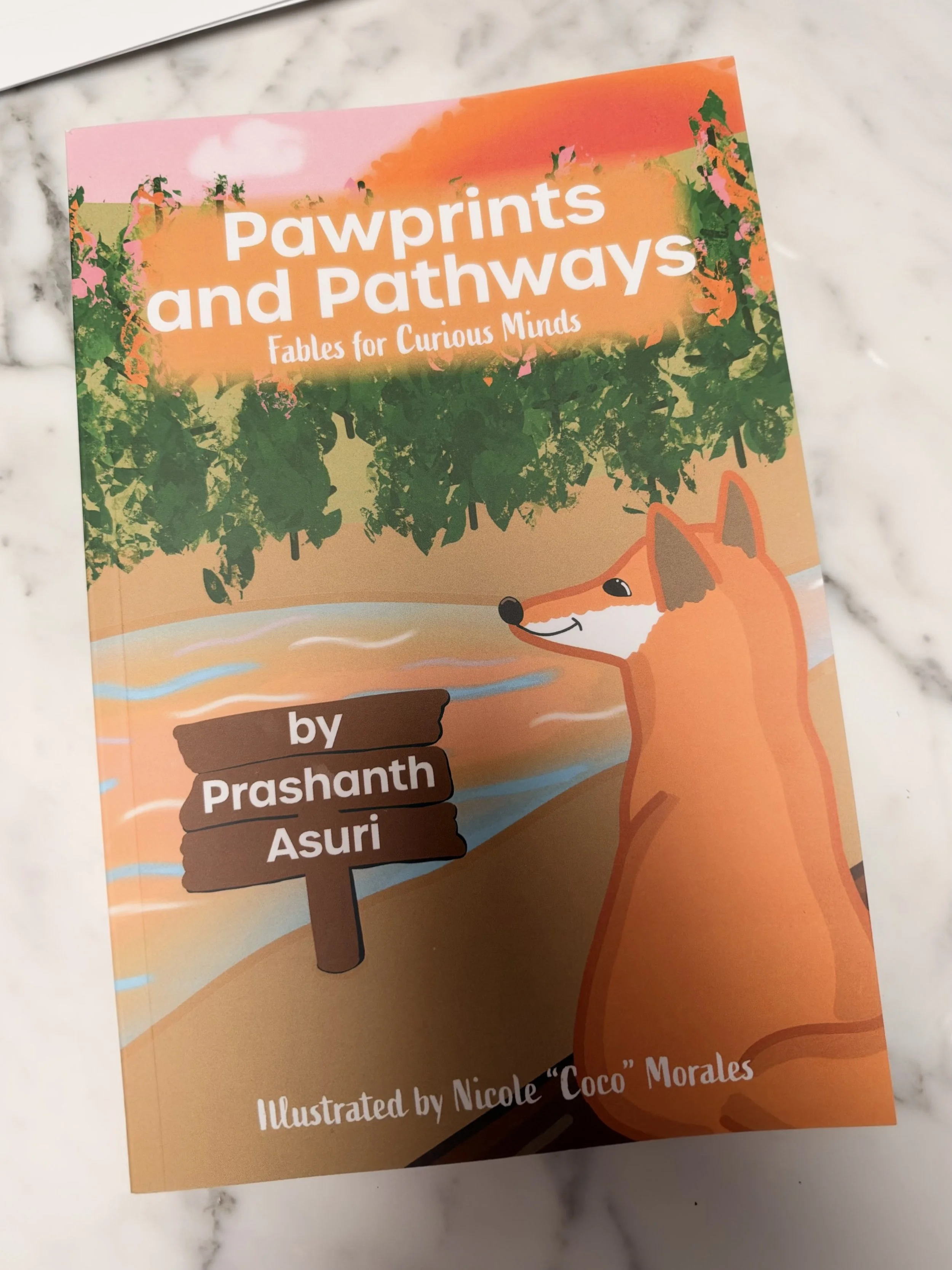 The book "Pawprints and Pathways Fables for Curious Minds" by Prashanth Asuri, Illustrated by Nicole "Coco" Morales