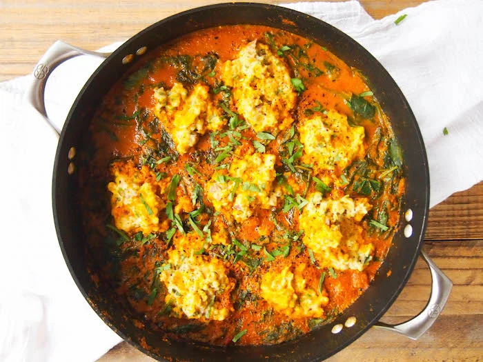 Chickpea Dumplings in Red Curry Coconut Spinach