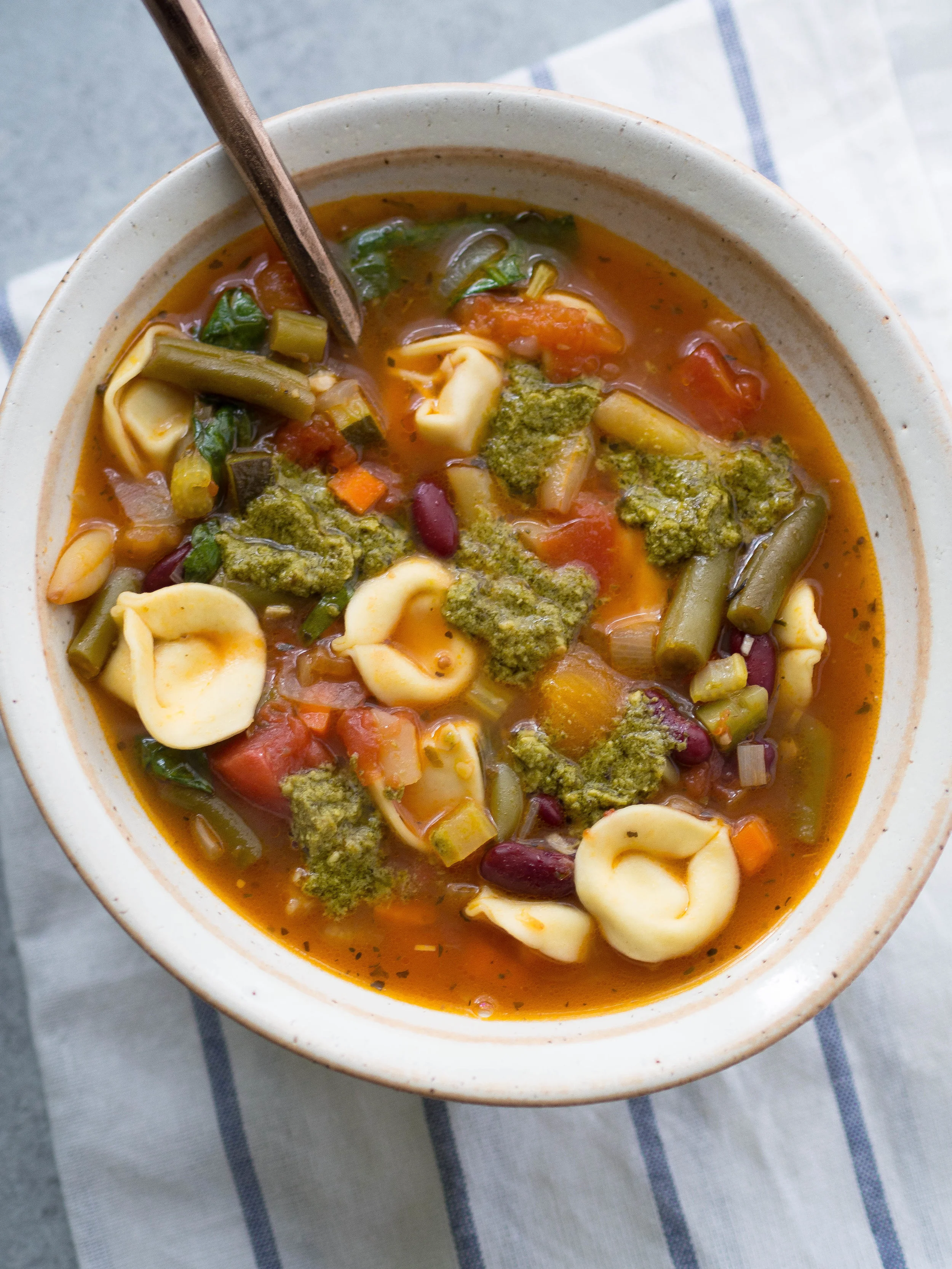 This Three Bean Tortellini Minestrone tastes like it’s been simmering all day, but you can make it in just over 30 minutes! #soup #tortellini #minestrone #minestronesoup #vegetarian #healthydinner