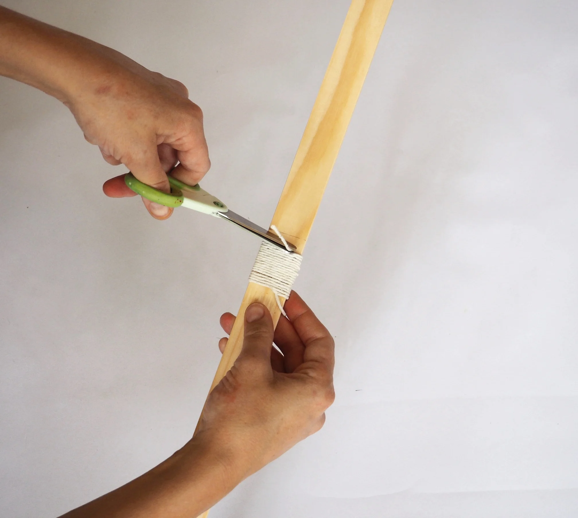  Take your scissor and cut off the string poking out the top of the binding. 