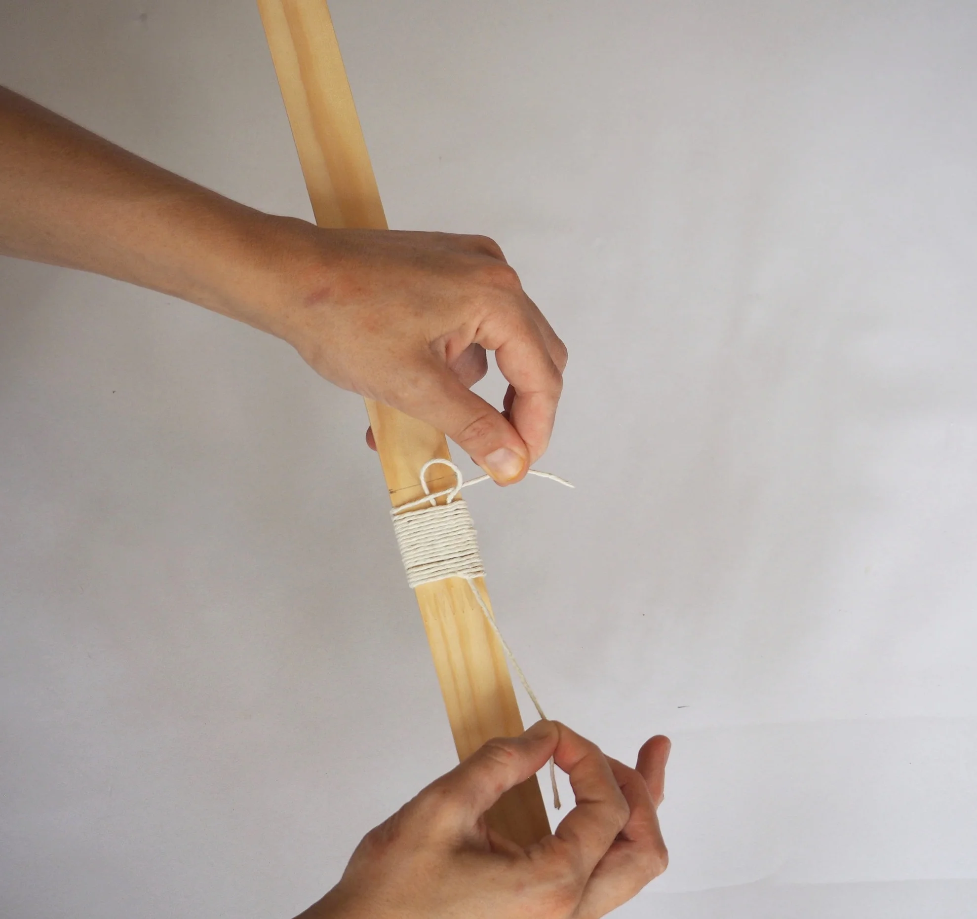  Then pull down on the end of the loop at the bottom of the binding. 