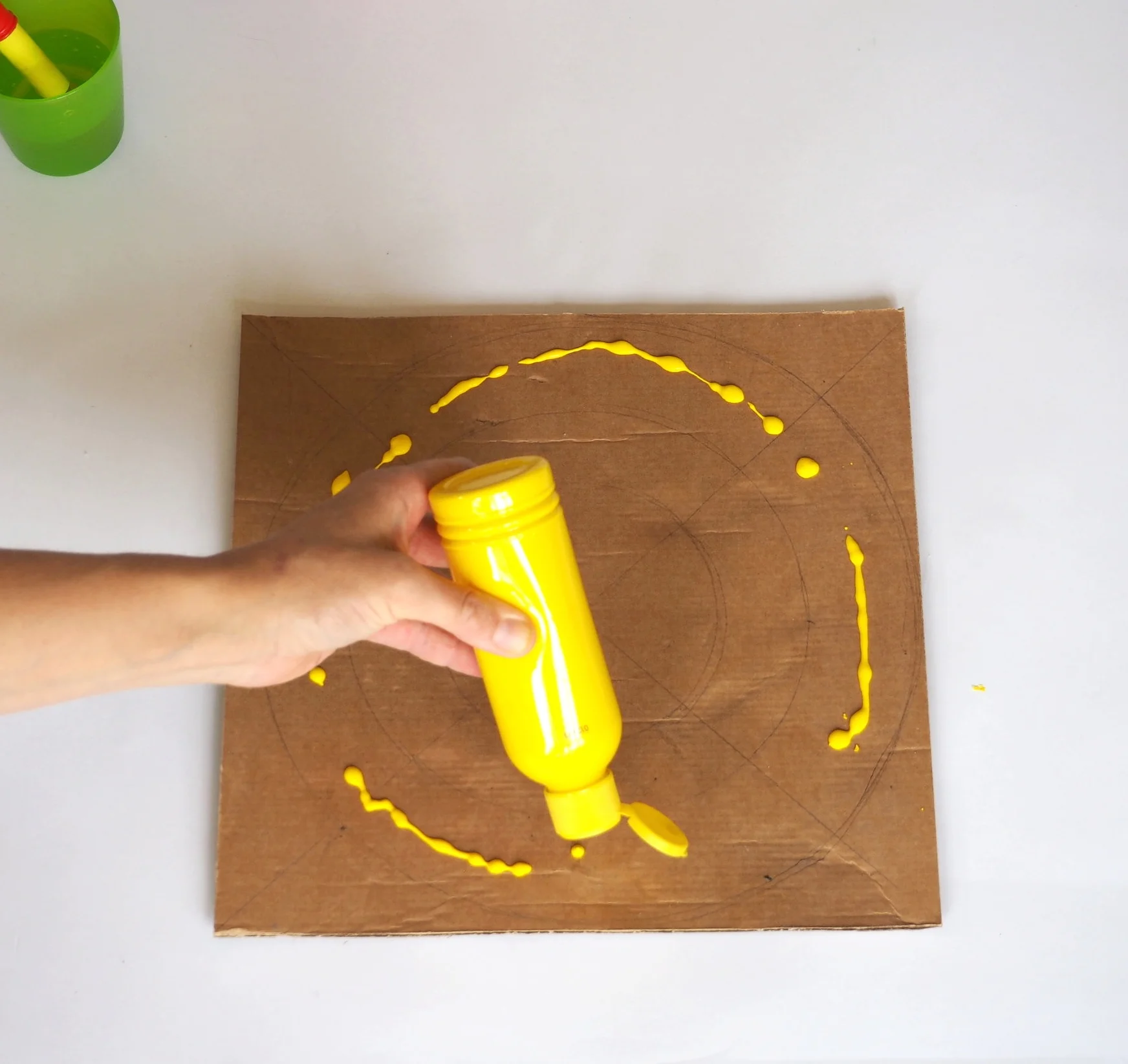  Using on of your colours of paint apply the first colour to the outer circle. 