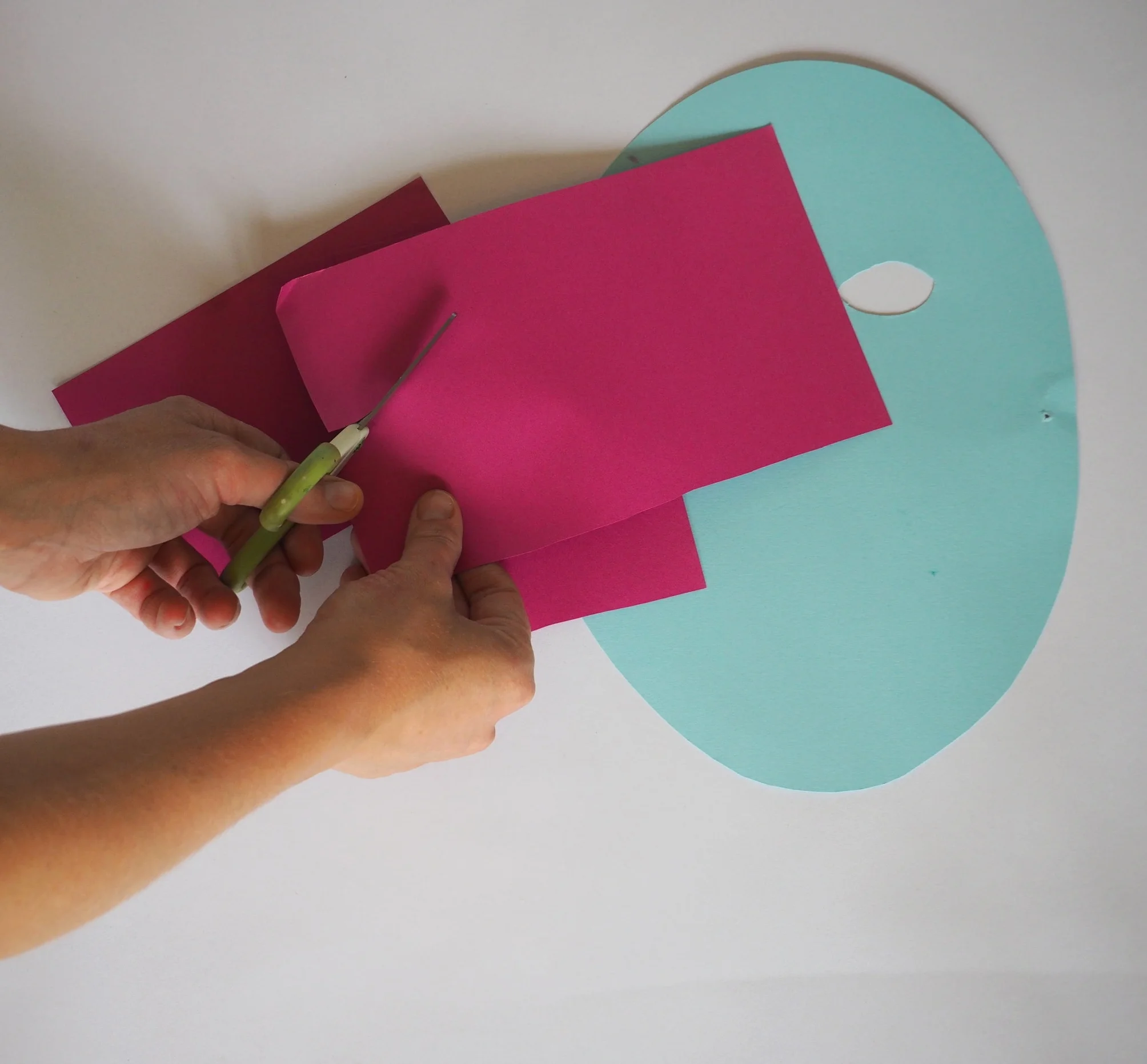  Take your coloured paper and cut out a selection of feather shaped pieces, or any other shape you like. 