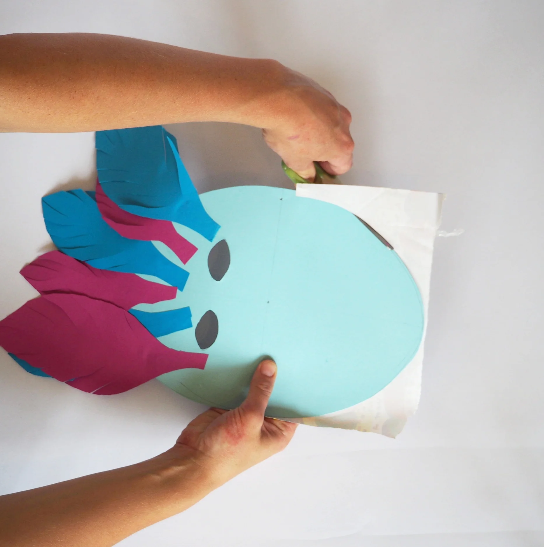  Cut the excess wrapping paper off from around the edge of the mask. 