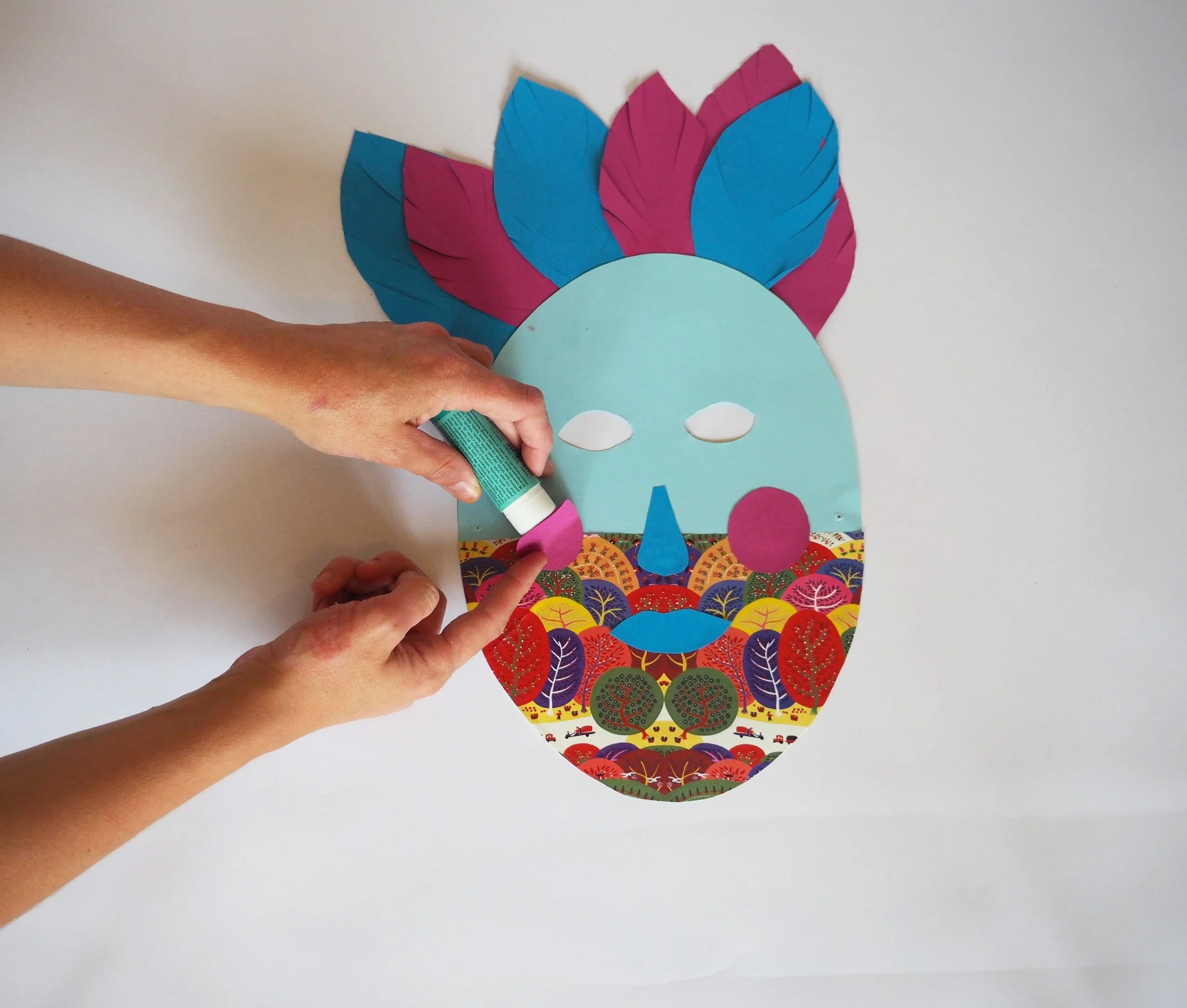  Cut out shapes for the lips, nose and cheeks for you mask and stick them on.  