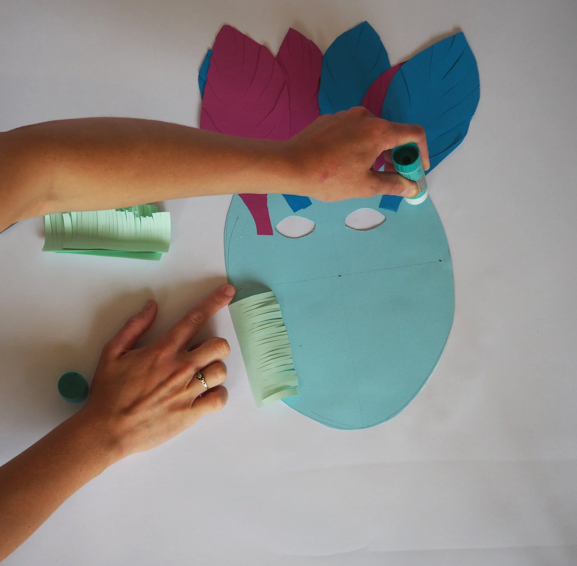  Apply glue around on the back of the mask around the edge. 