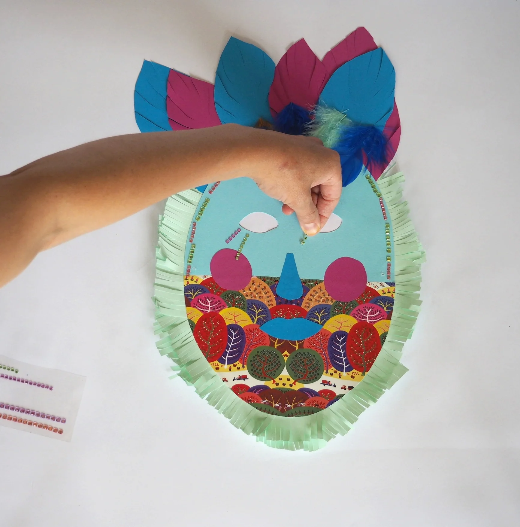  Now stick your sparkly gems, or sequins anywhere on your mask to finish off decorating.  