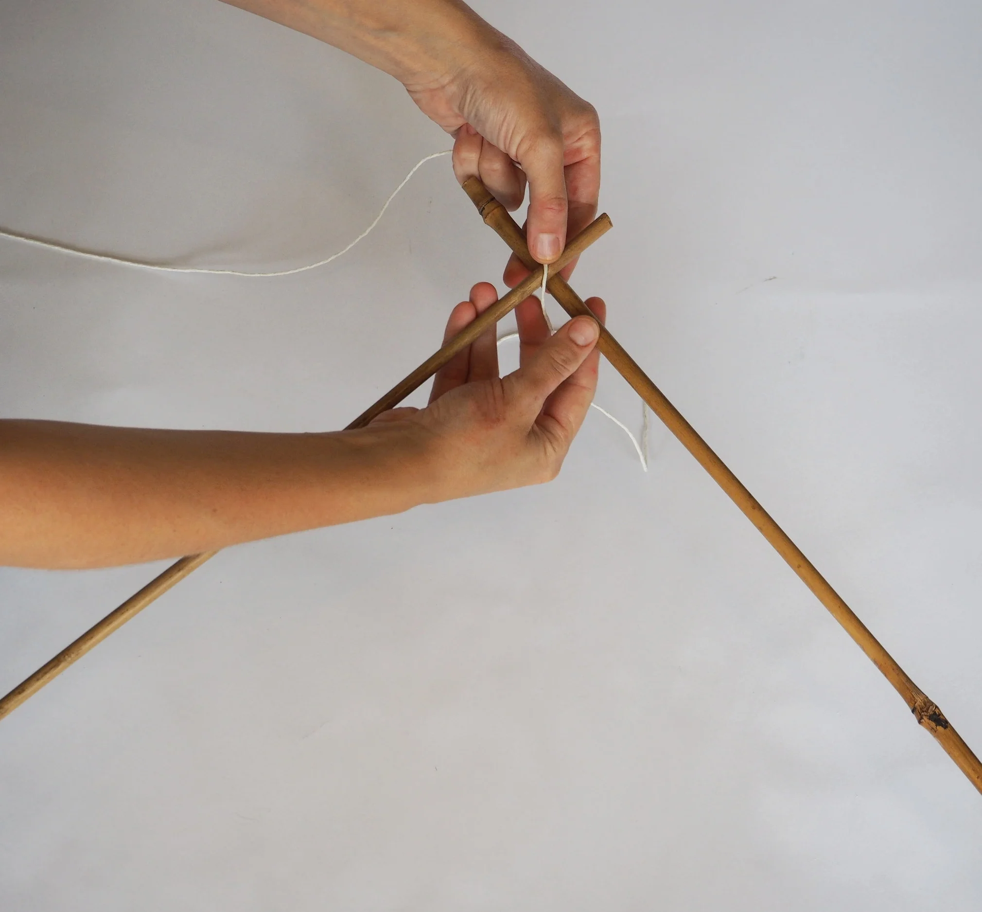  Using three of the 110cm canes tie them into a triangle, you will need to cut approximately 50cm of string for each join. 