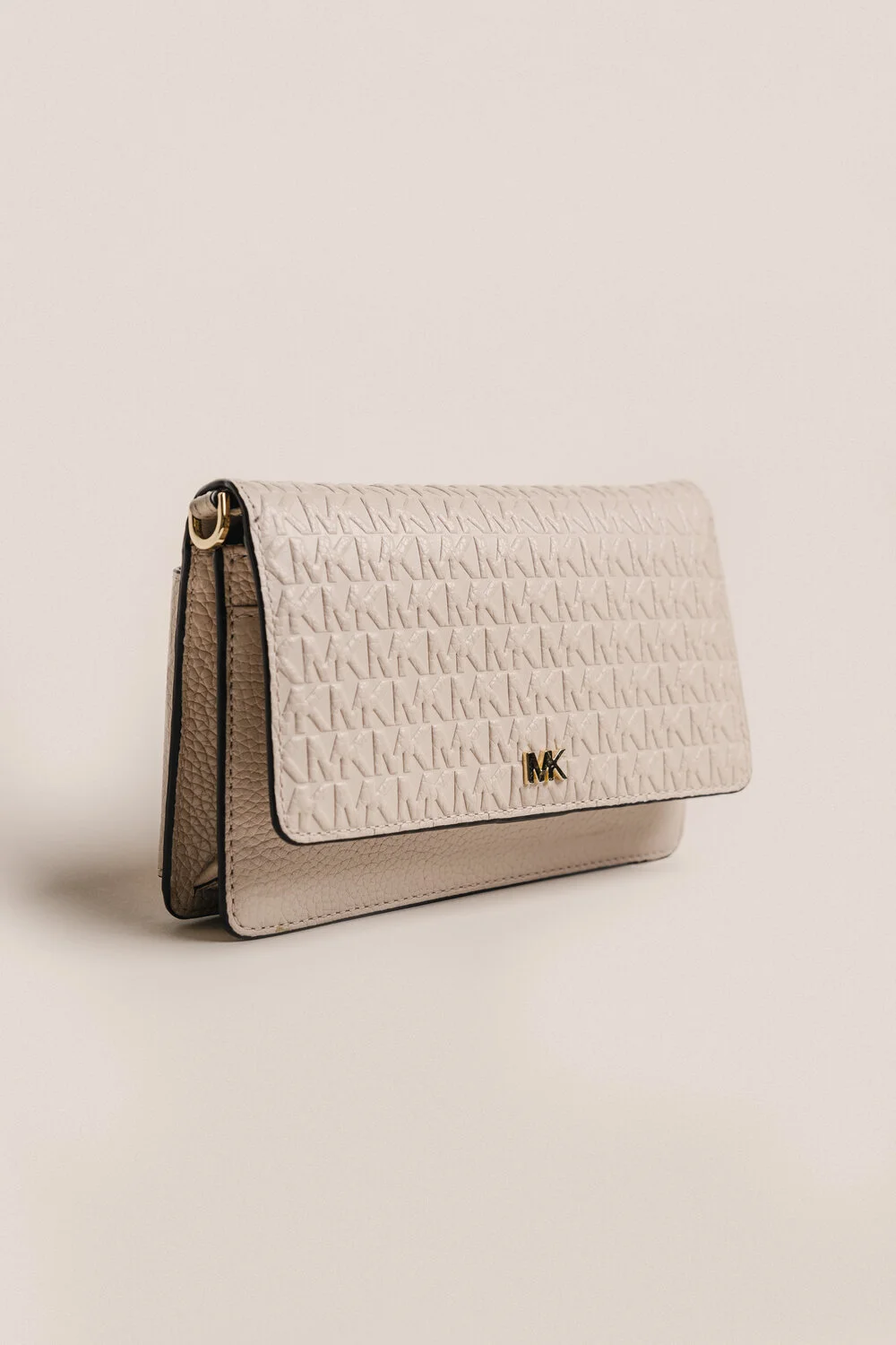 A beige Michael Kors handbag with a textured pattern and gold MK logo on the front.