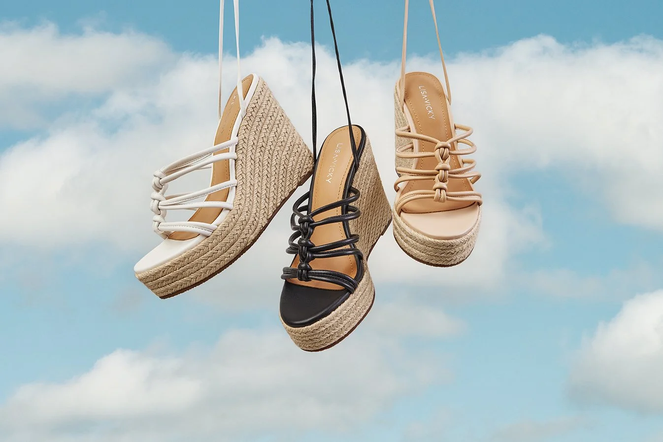Three women's platform wedge sandals hanging against a sky with clouds, featuring different colors: white, black, and beige.