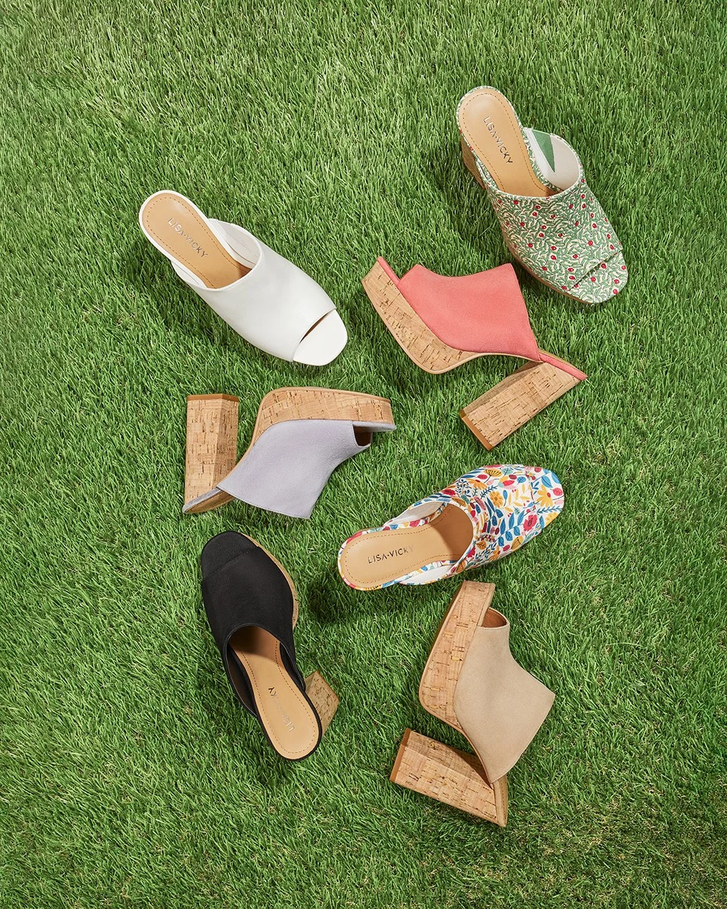 Six different pairs of women's shoes with block heels placed on green grass. The shoes vary in color and style, including black, beige, white, floral patterned, gray, and pink with cork heels.