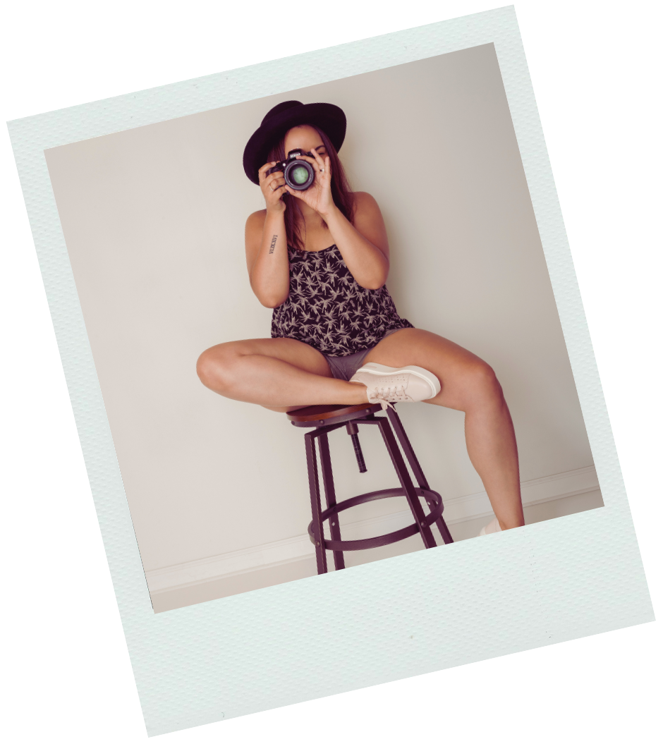 polaroid image of a woman sitting on a stool with a camera to her face