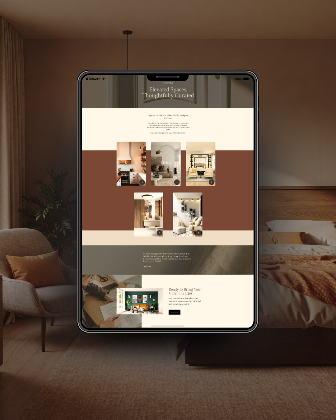 A tablet displaying a website about interior design and curated spaces, set against a cozy bedroom background with a bed, armchair, and plants.