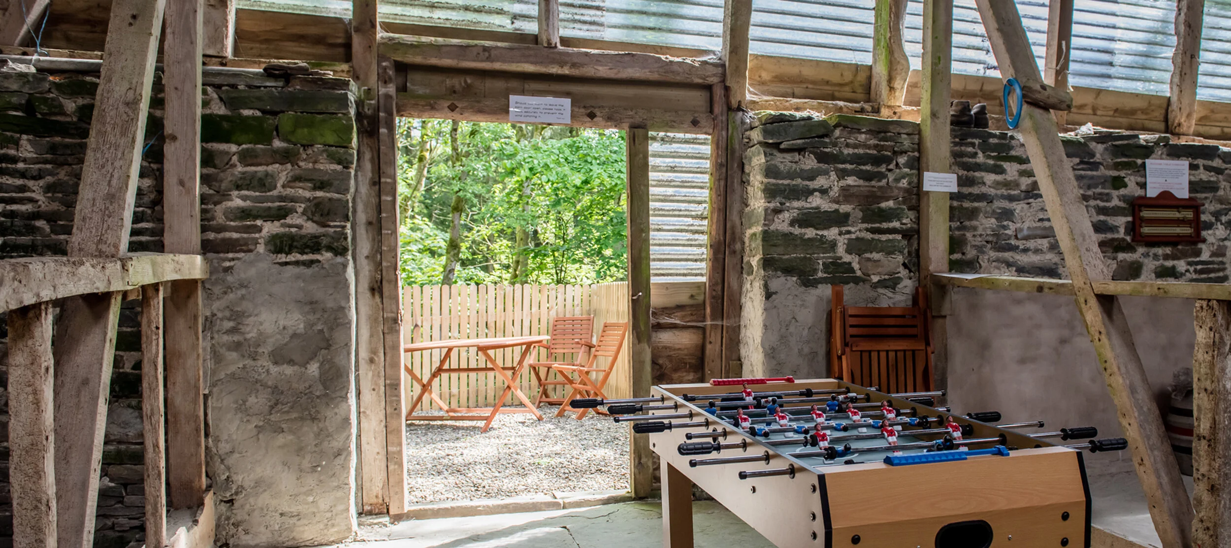 Table football in our games barn leading to the outside woodland seating