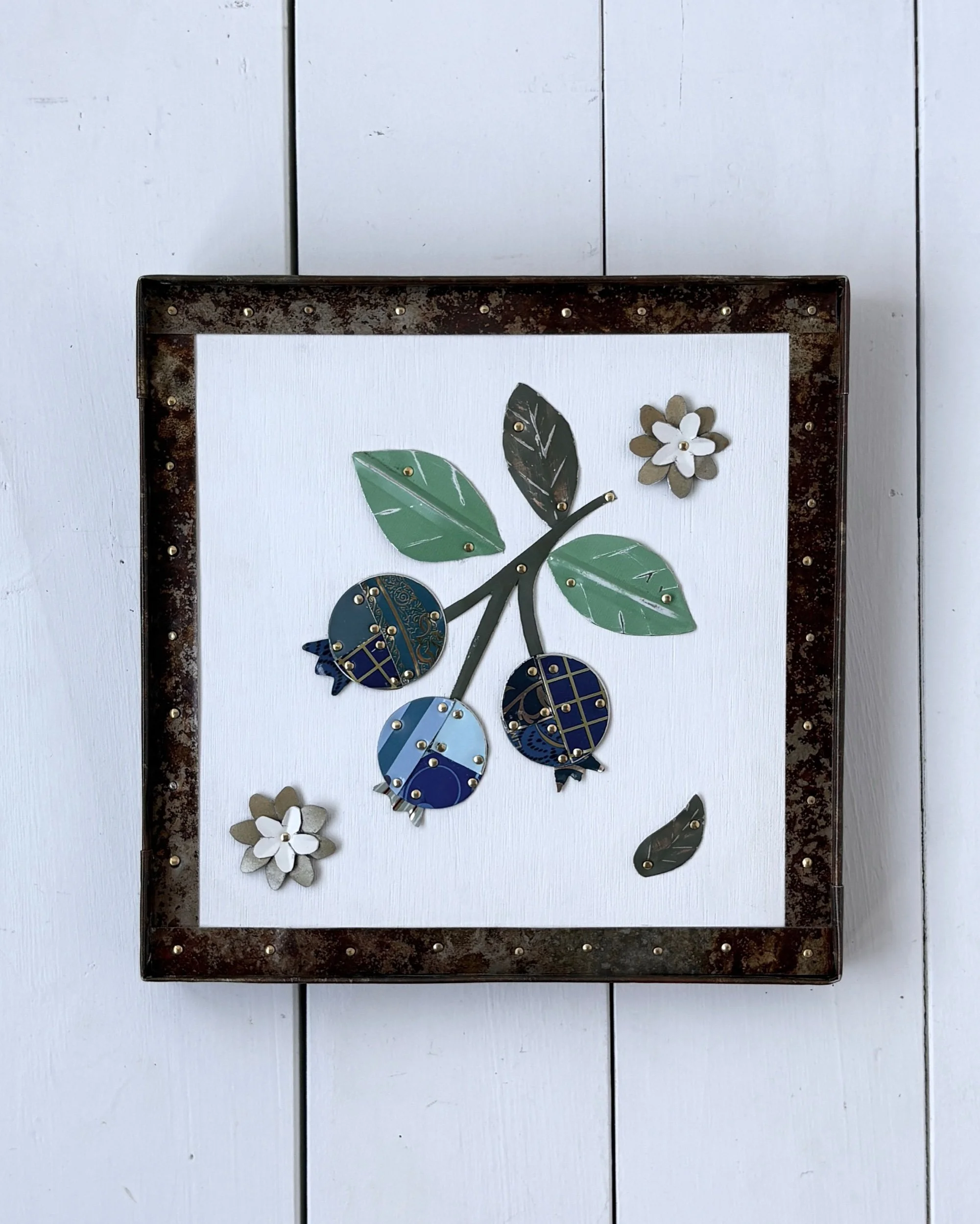 Handmade blueberry tin collage wall art framed in preserved rusty tin with natural patina
